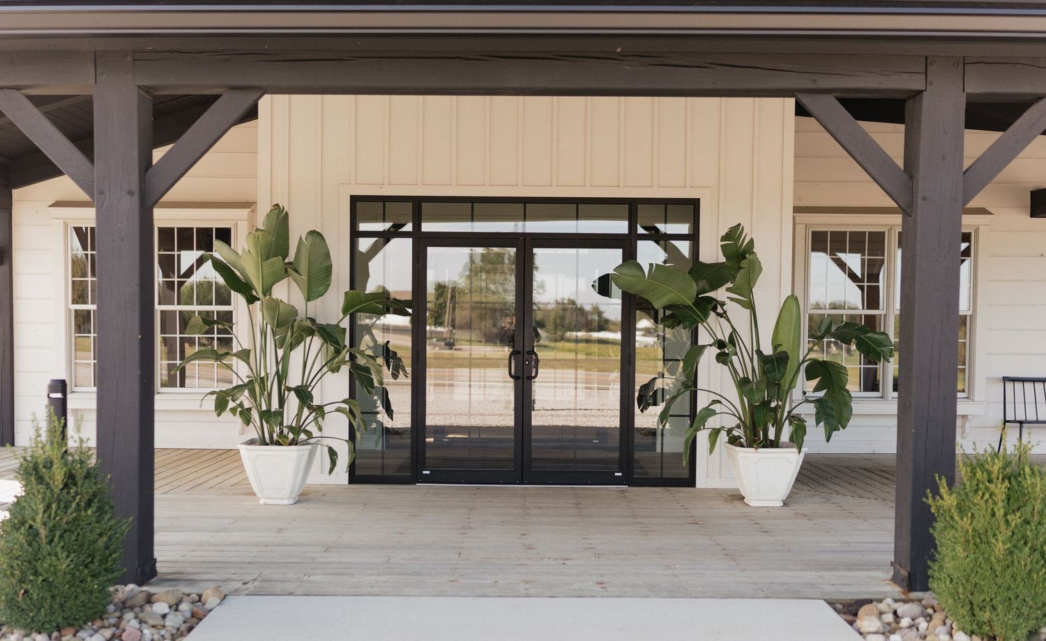 Modern covered walkway with white columns and desert landscaping connects buildings at an upscale commercial property.