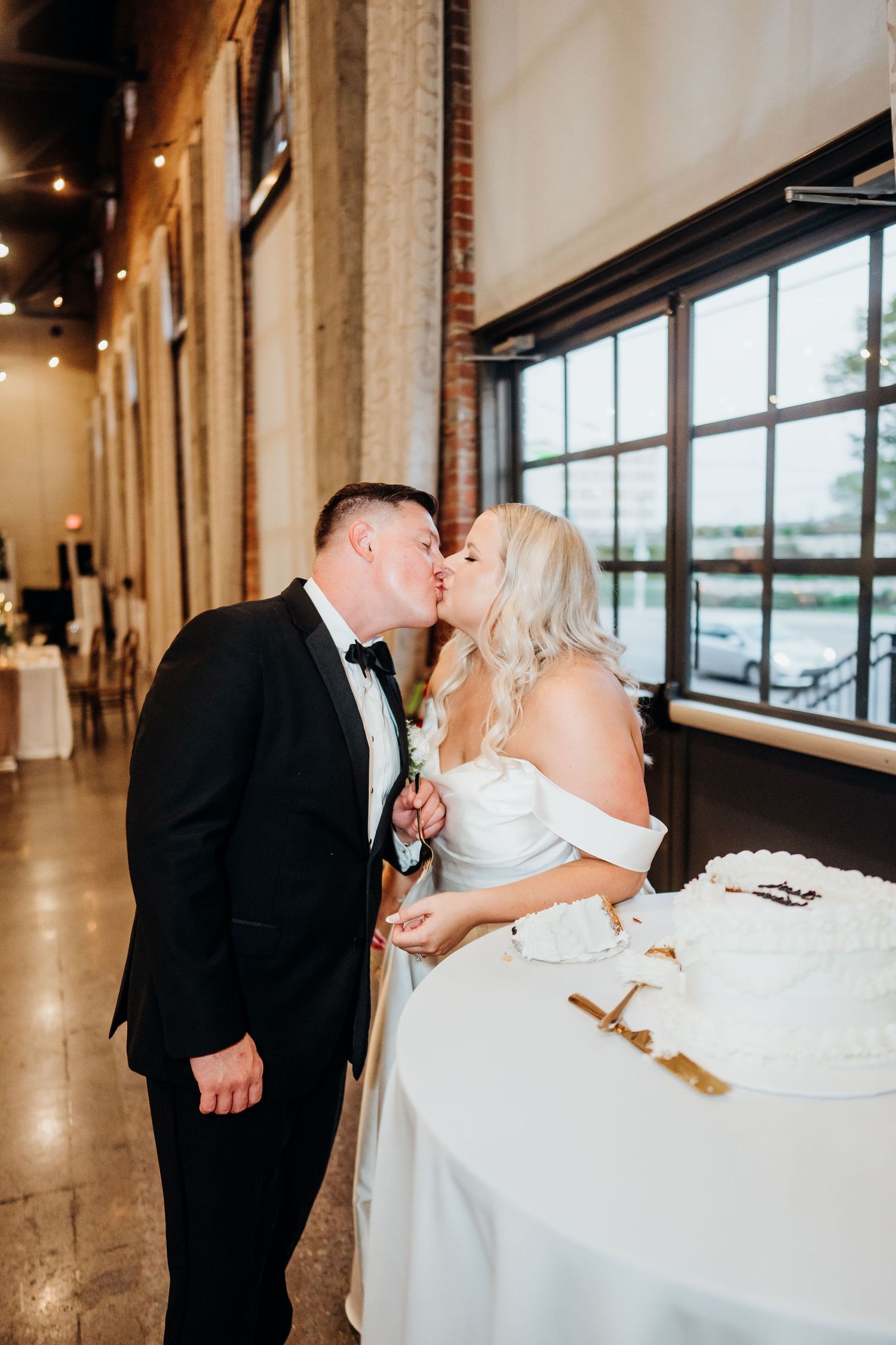 Romantic wedding couple shares intimate moment at reception venue.