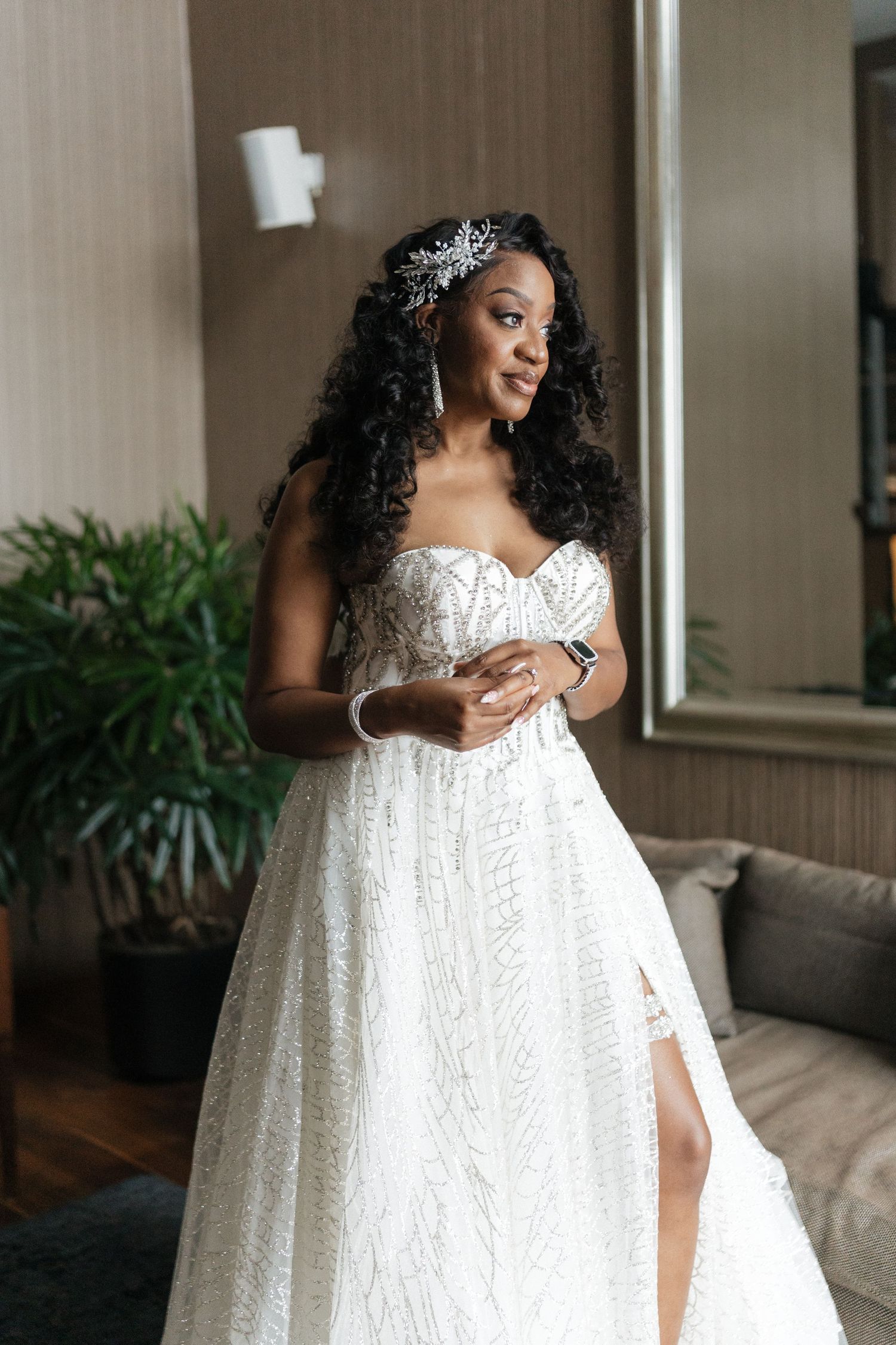 Beautiful strapless white wedding gown with lace details and sweetheart neckline features elegant beaded hair accessory.
