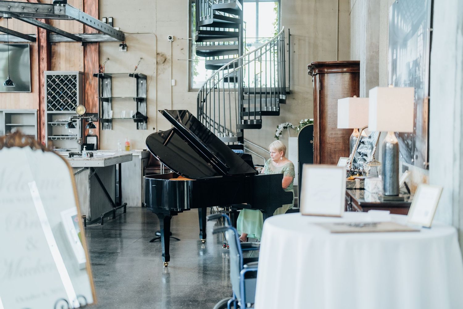 Elegant wedding venue interior featuring industrial architecture and natural lighting.