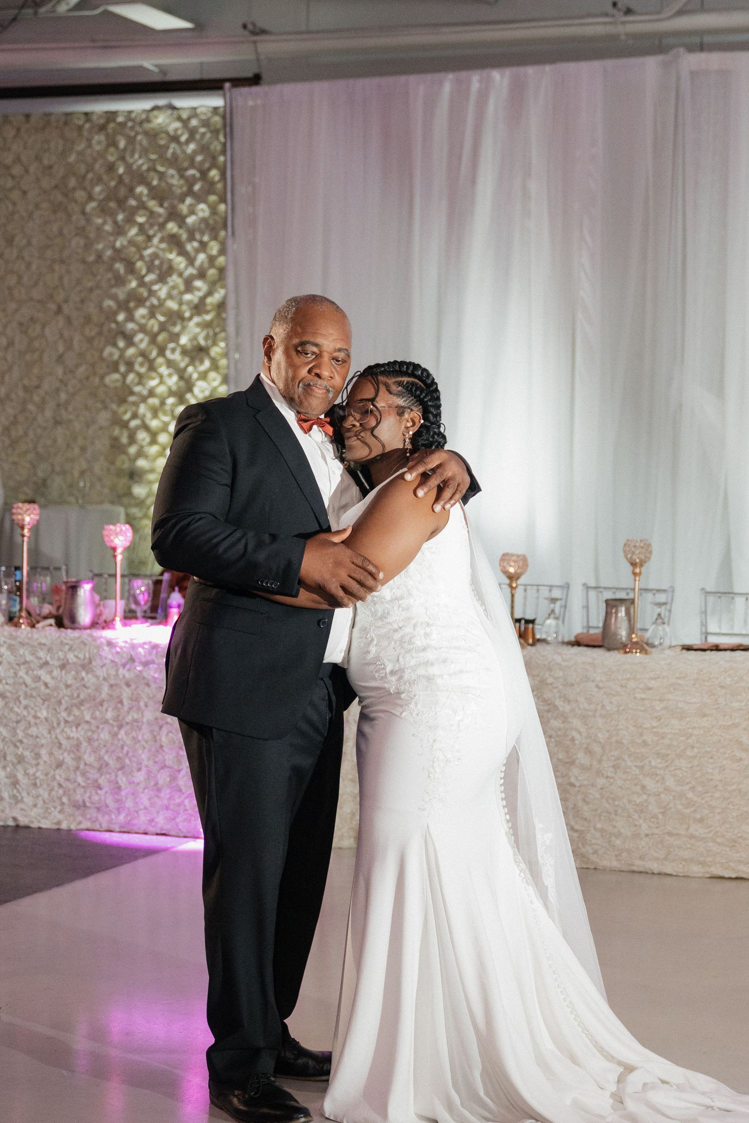 An emotional dance between two wedding guests during the reception celebration.