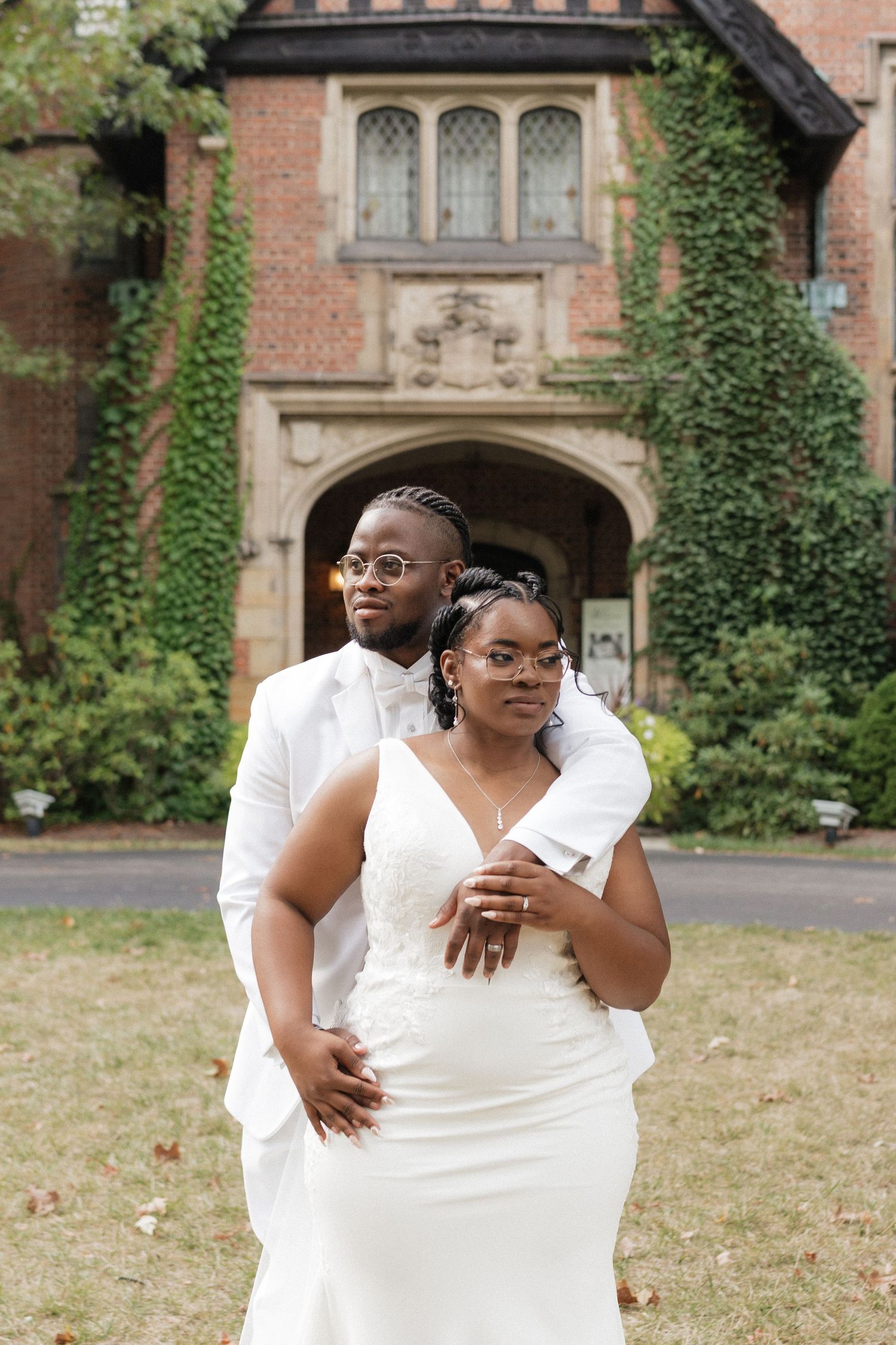 A romantic wedding photoshoot in front of an ivy-covered brick building with Gothic architecture.