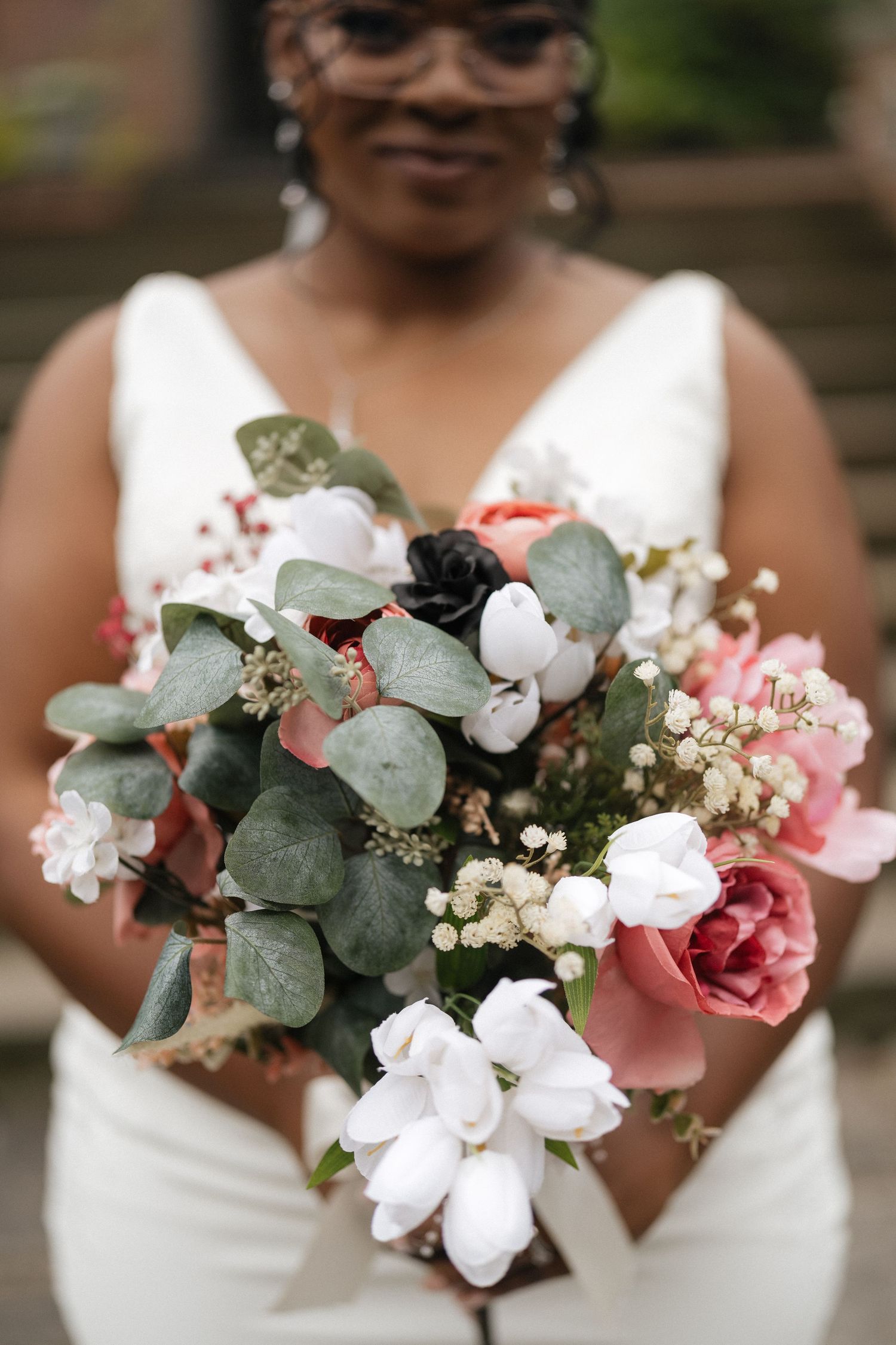 Elegant bridal bouquet with eucalyptus, white orchids and pink flowers.