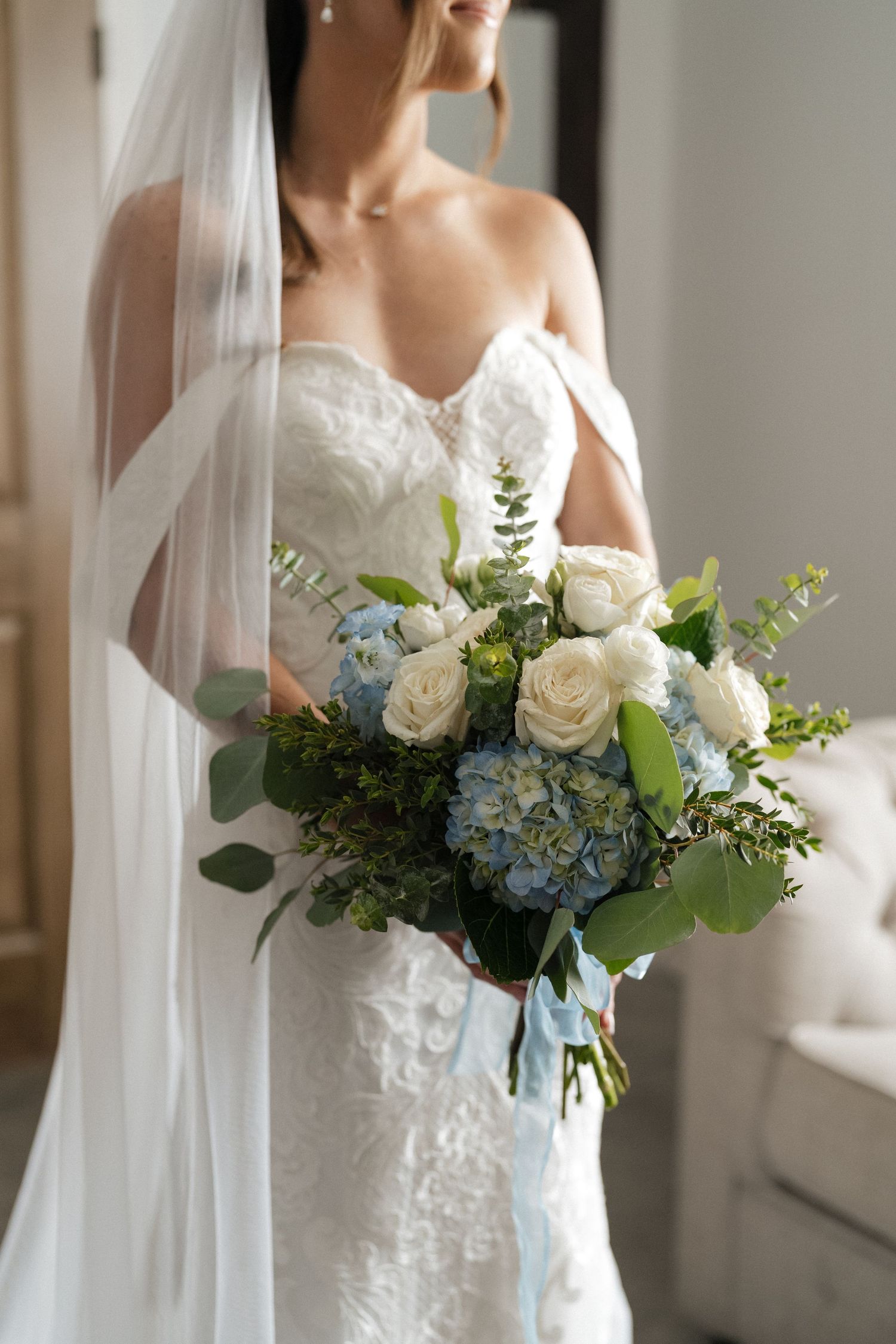 Bride getting ready beside a window before her Cleveland wedding