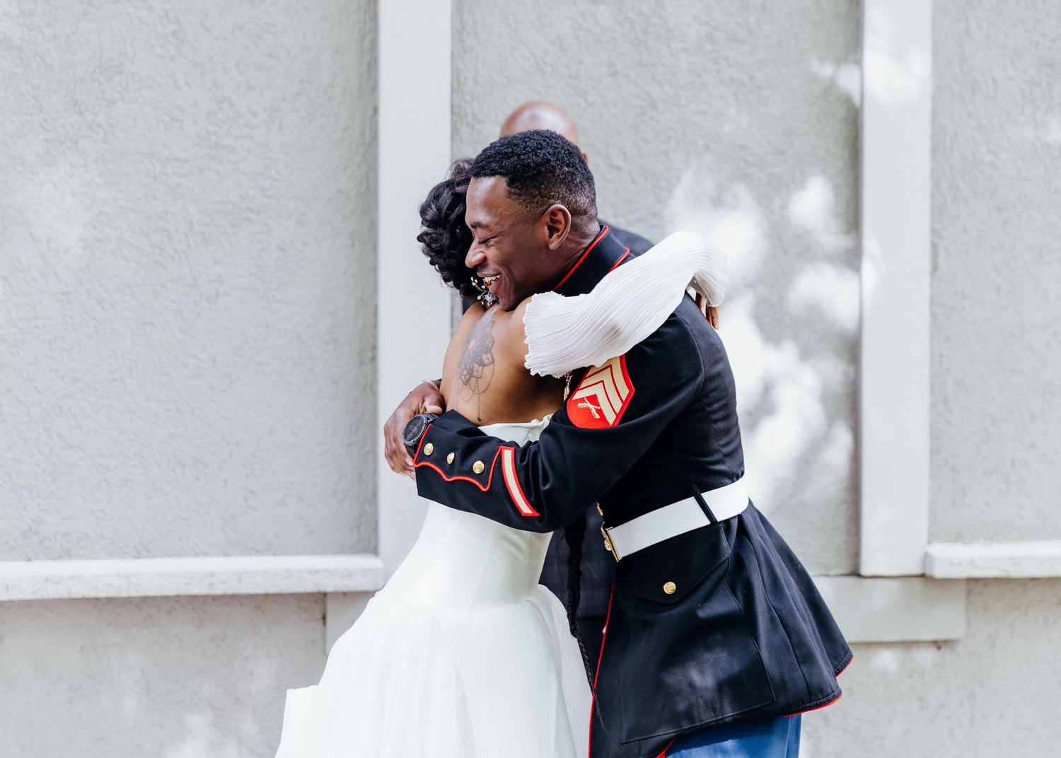 Emotional wedding moment captured in black and white against neutral background.