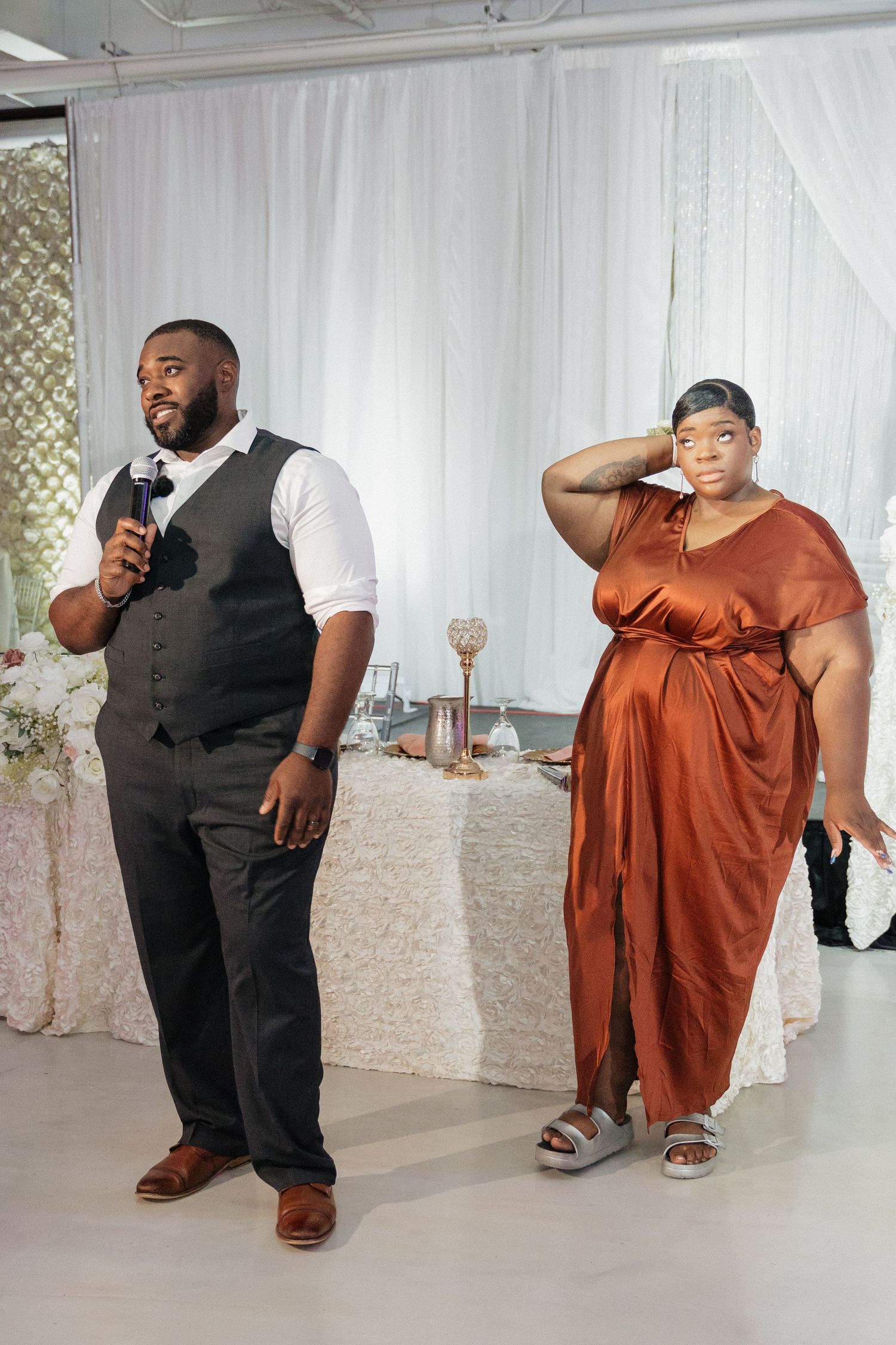 Wedding reception candid moments with guests in formal attire dancing and celebrating.