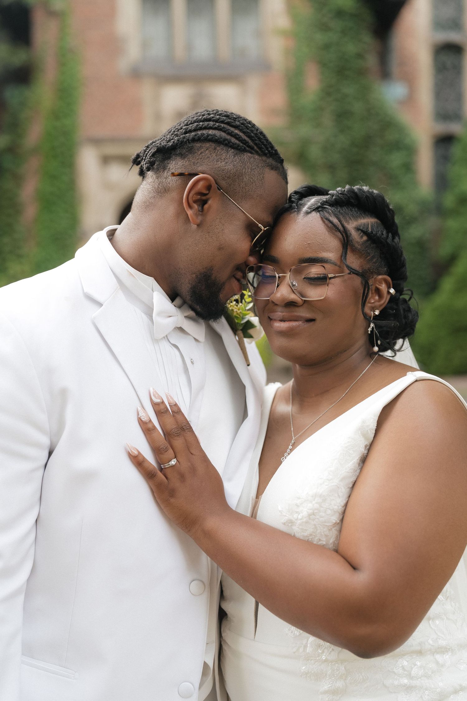 Romantic outdoor wedding photo series showing tender moments between newlyweds in white attire against greenery.
