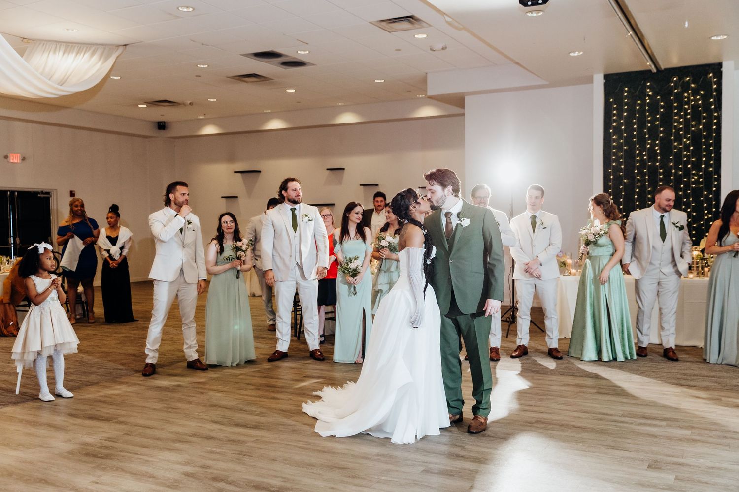 Wedding reception in modern indoor venue with mint green and white color scheme.
