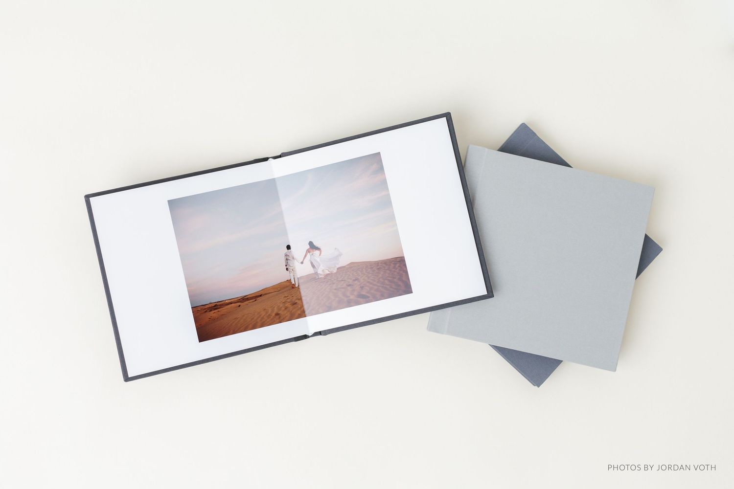 Minimalist gray wedding photo album box set with desert engagement photo.