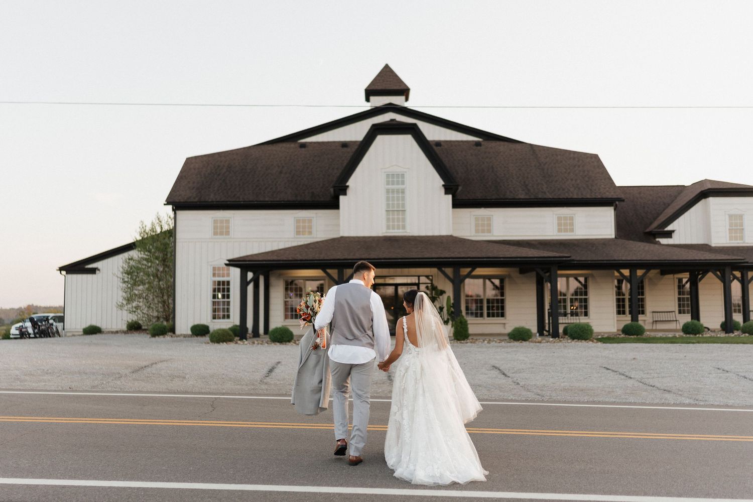 Exterior view of wedding venue with classic architecture and dark roof.