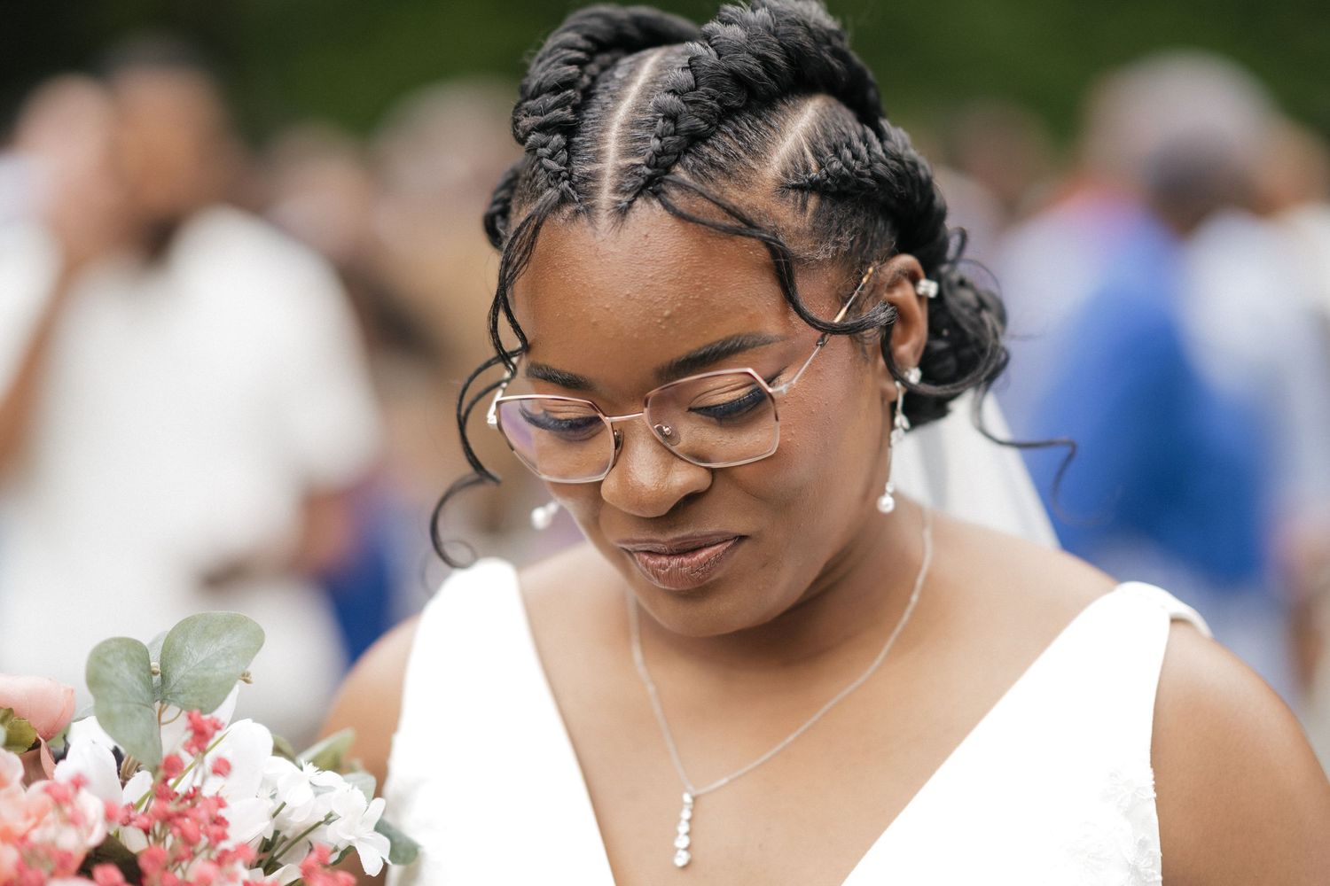 Close-up wedding portrait showing elegant bridal details including glasses and floral accents.