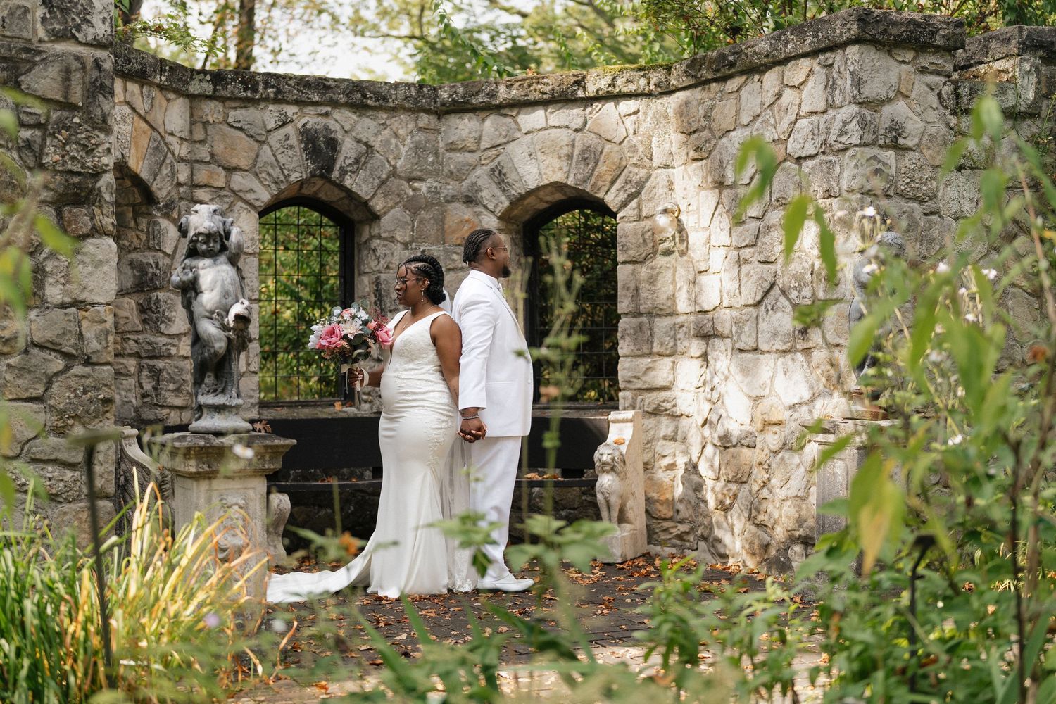 Wedding photos captured against rustic stone ruins with natural greenery and archways.