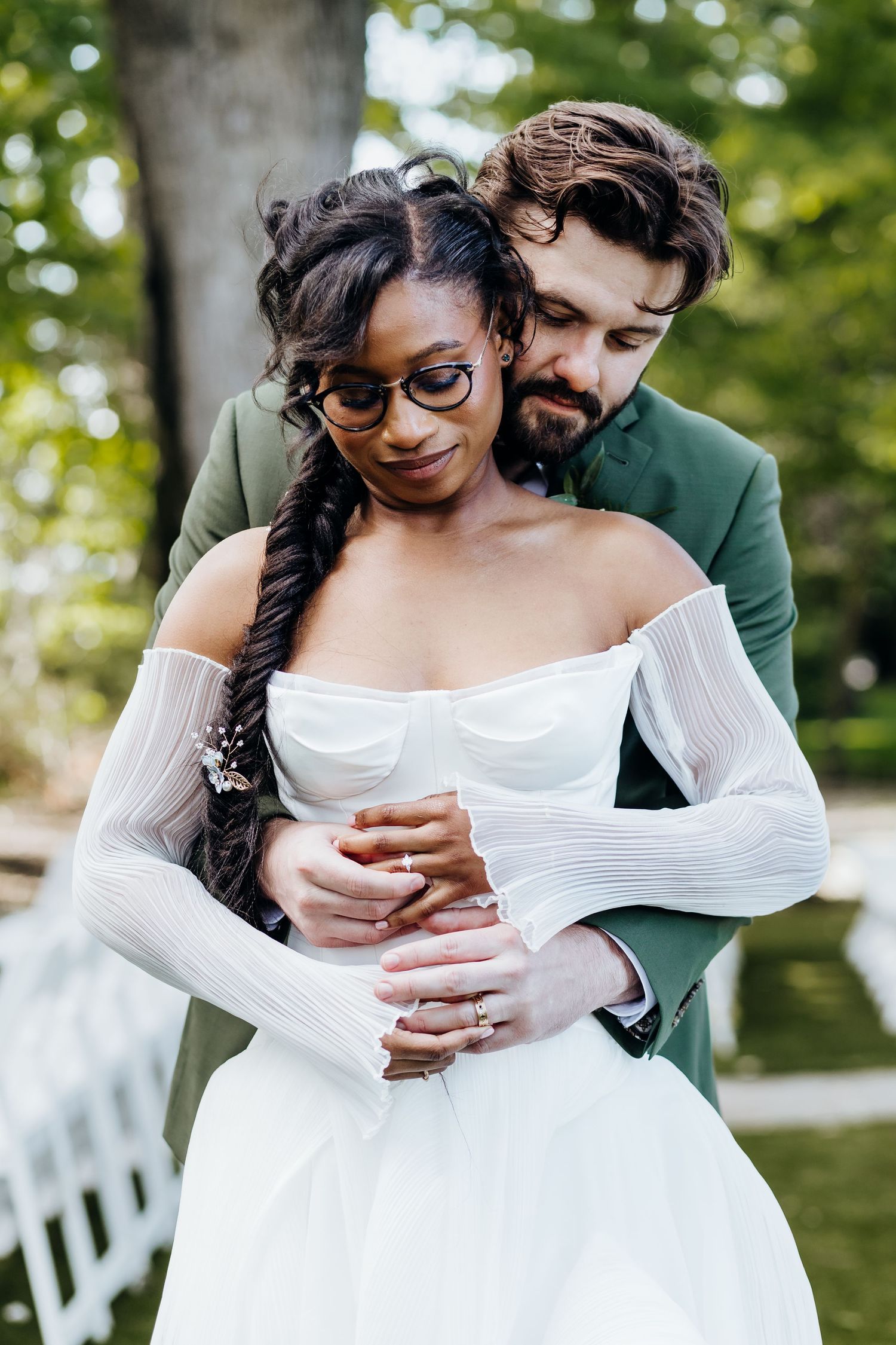Intimate wedding couple moment captured in outdoor garden setting.