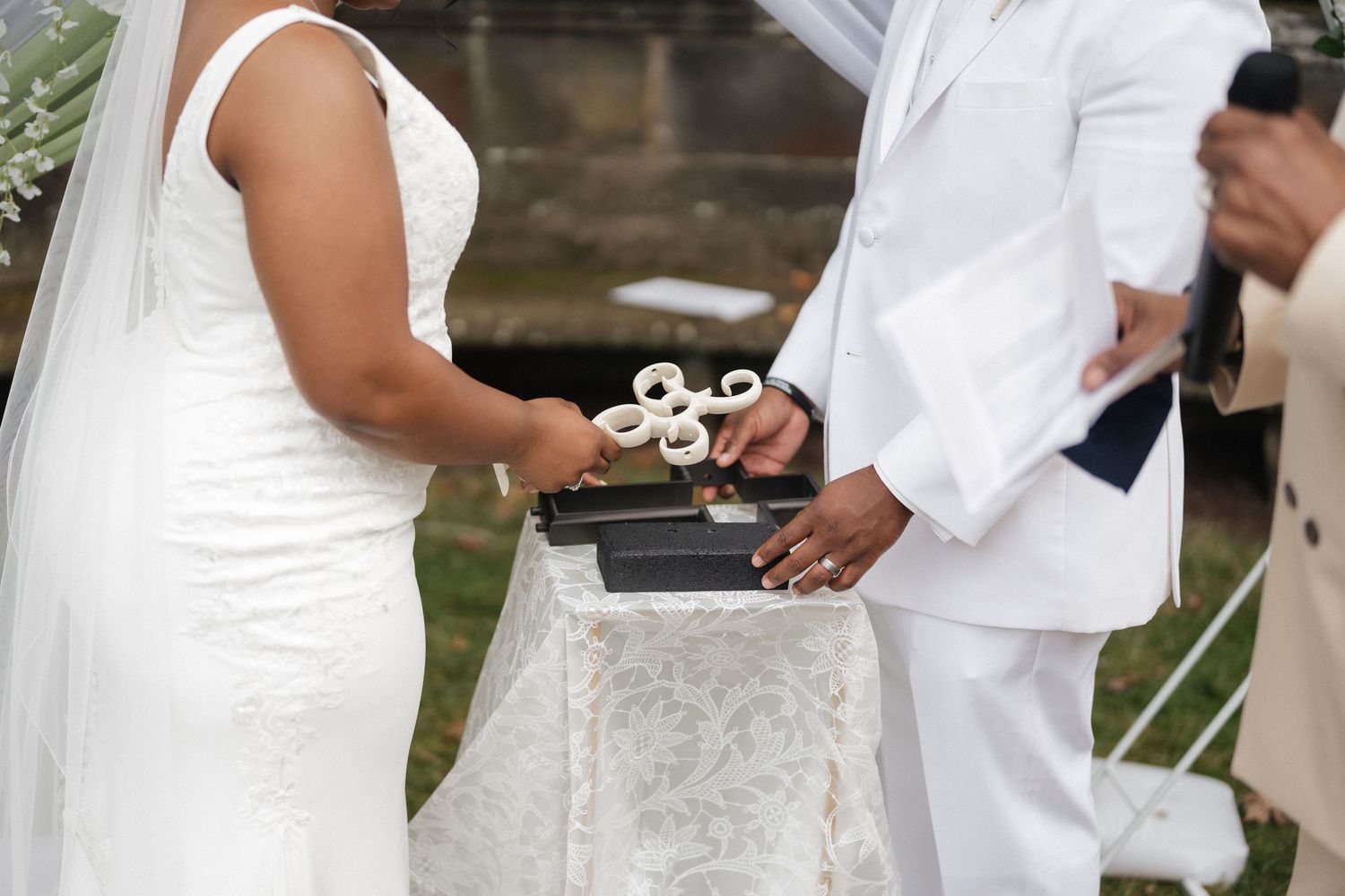 Close-up of hands exchanging rings during a wedding ceremony.