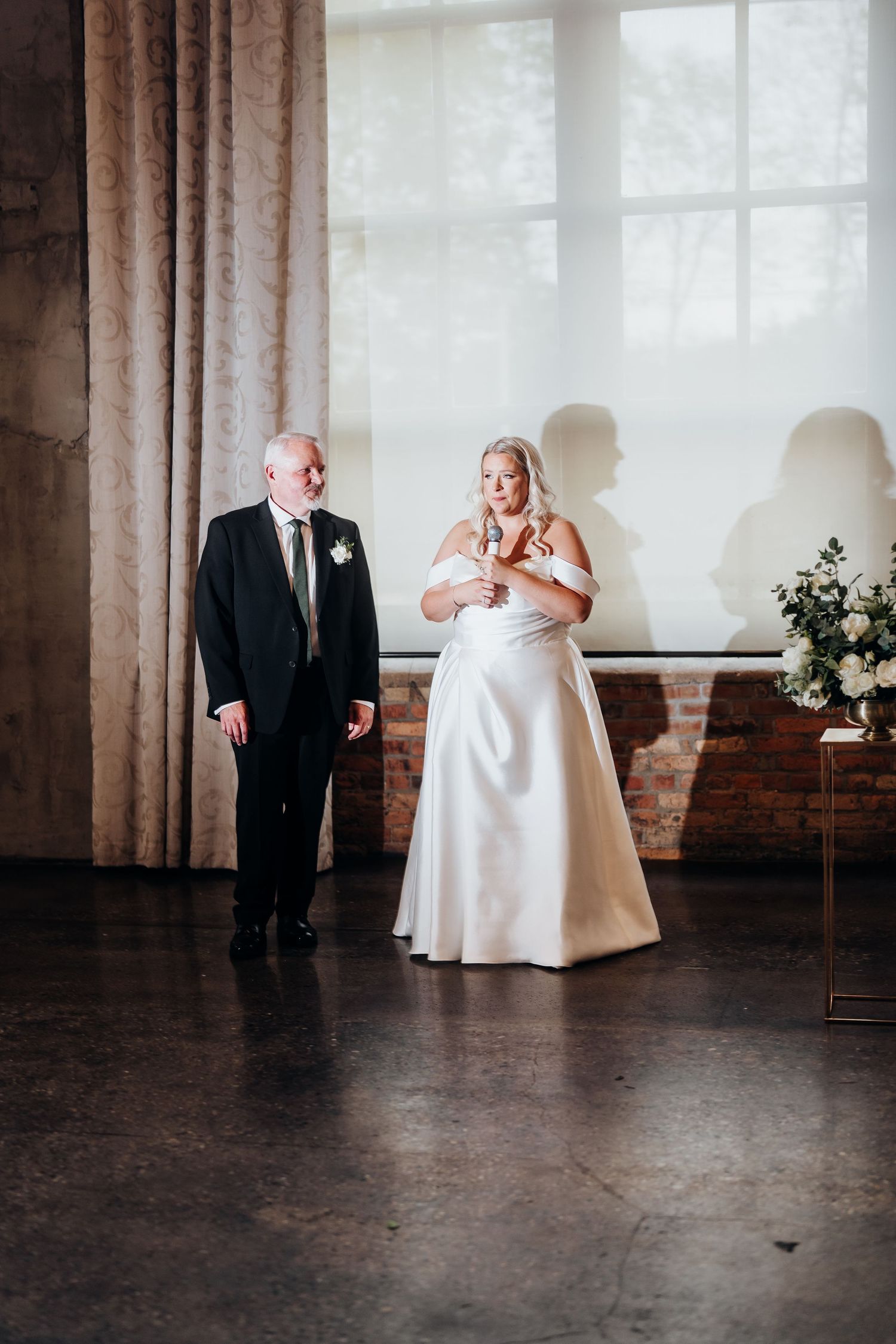 A sequence showing a couple's first dance in a rustic venue with brick walls.