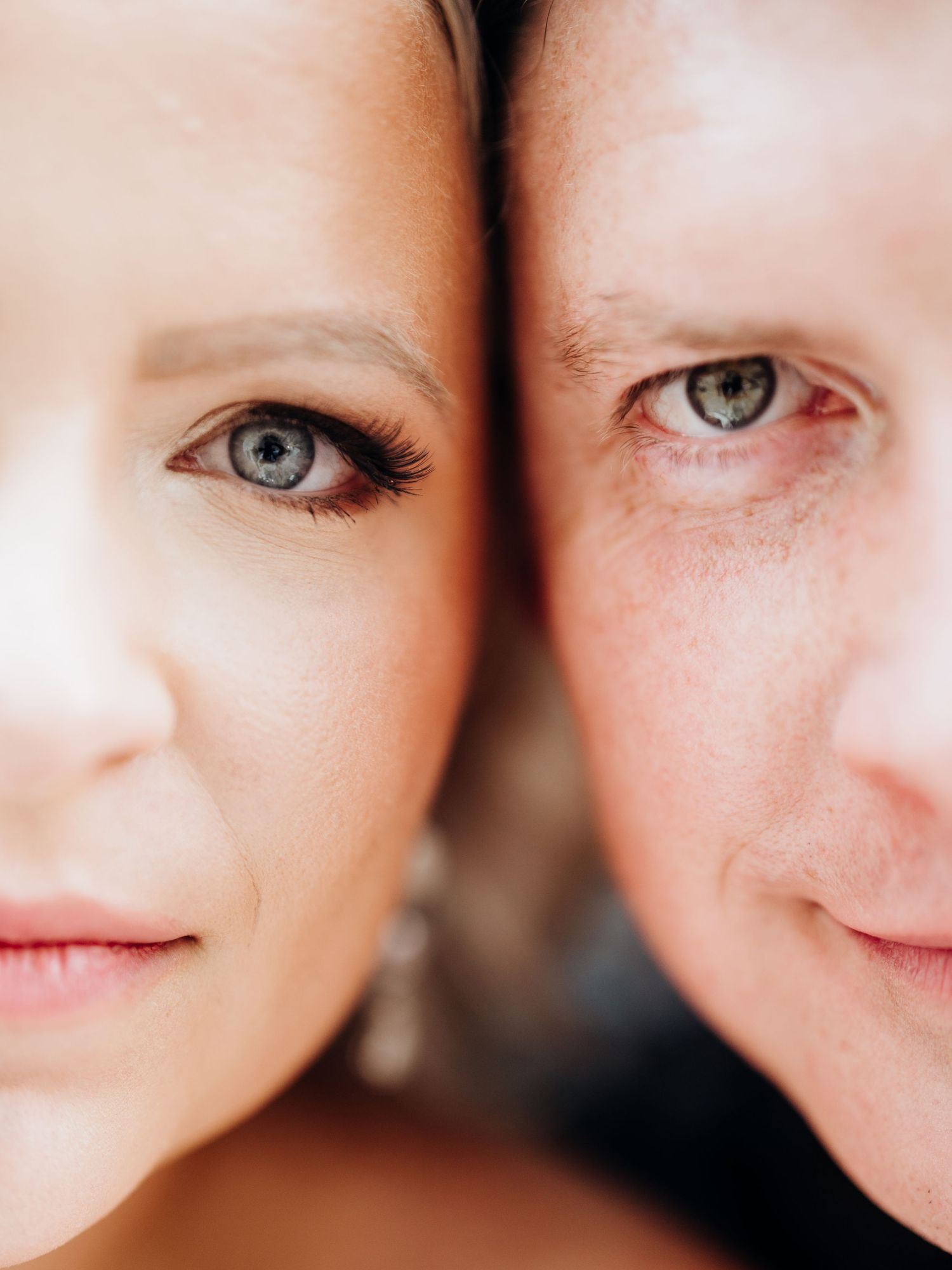 Extreme close-up portrait showing bright blue eyes and natural skin texture.