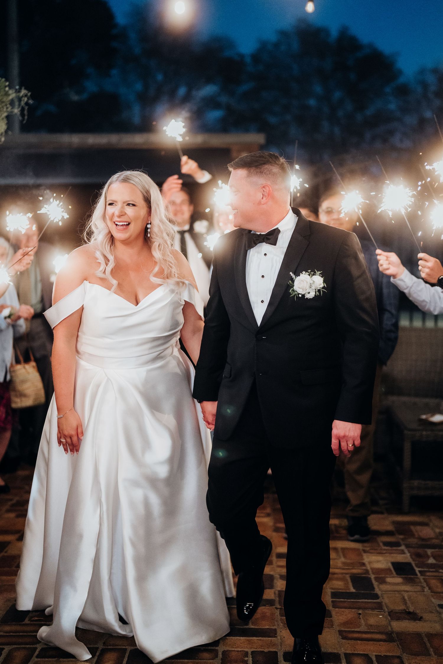 Wedding celebration at night with sparklers creating a magical atmosphere.