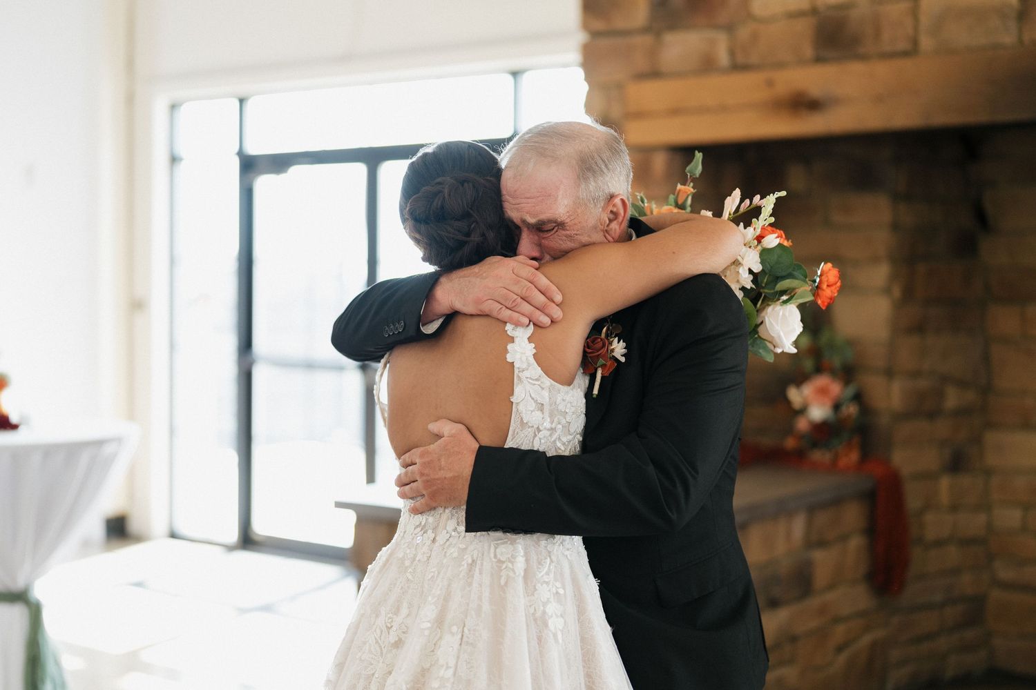Romantic wedding ceremony moment captured in a rustic brick venue.