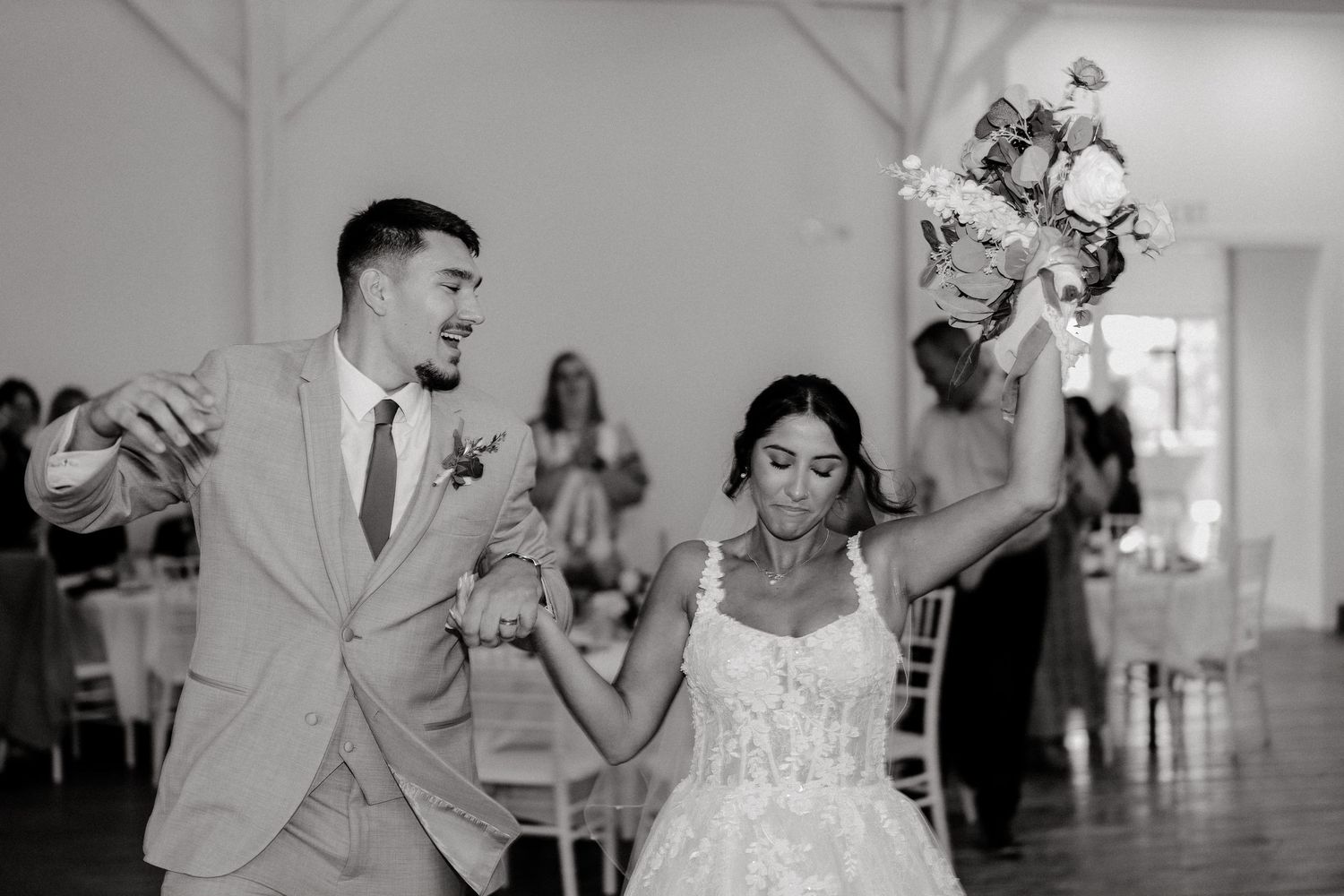 Wedding reception dance captured in black and white showing joyful celebration.