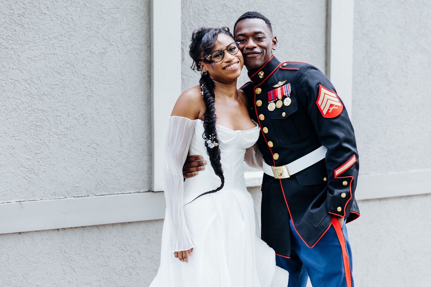A series of romantic wedding photos showing a couple embracing in front of a light colored wall.