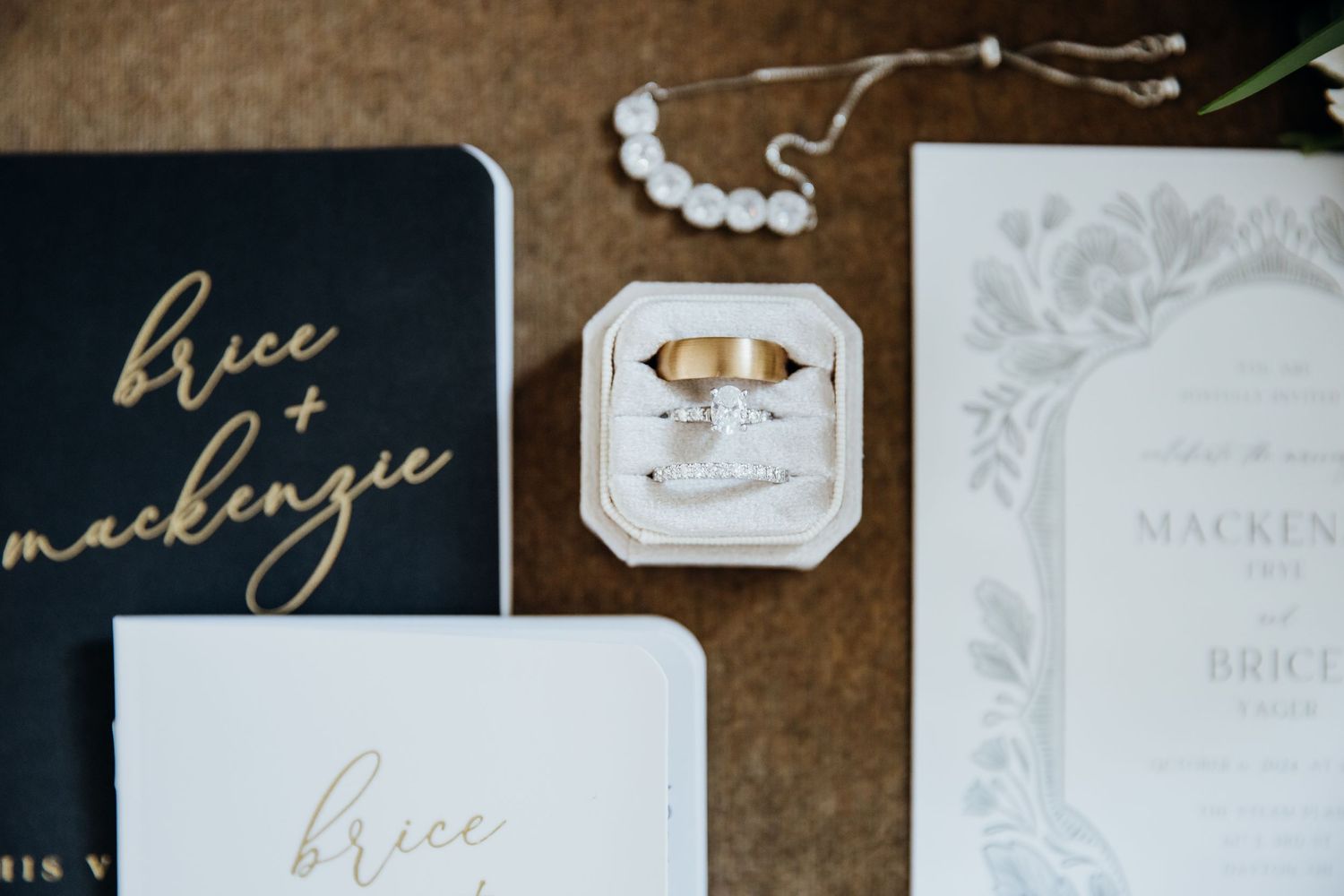 Elegant wedding stationery collection featuring gold calligraphy and floral designs on cream and white paper.