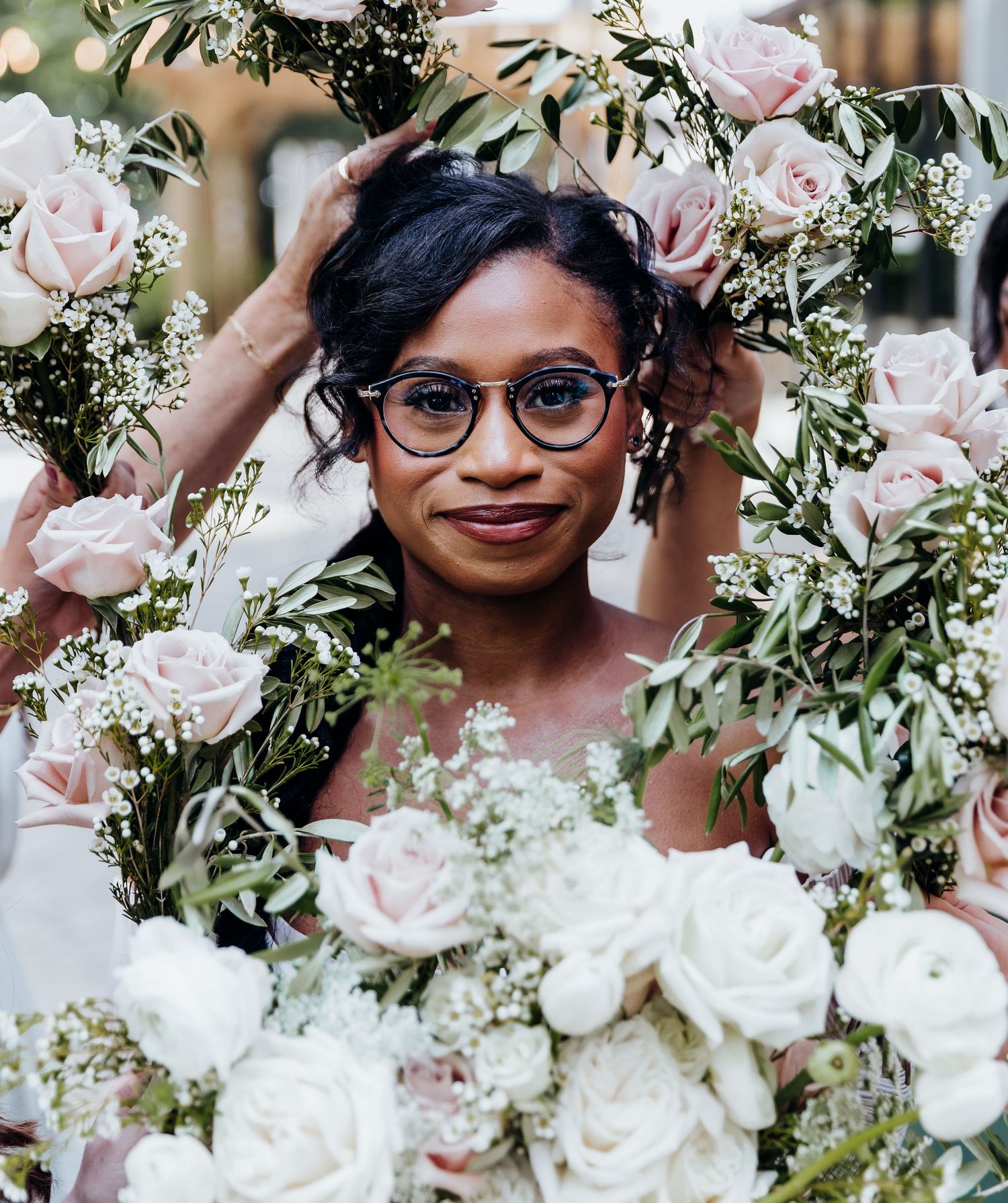 Close-up of delicate pink and white rose bouquet with greenery.