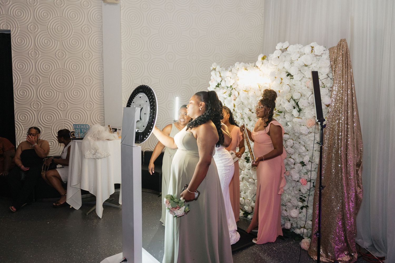 Wedding reception setup with floral arrangements and elegant table settings.