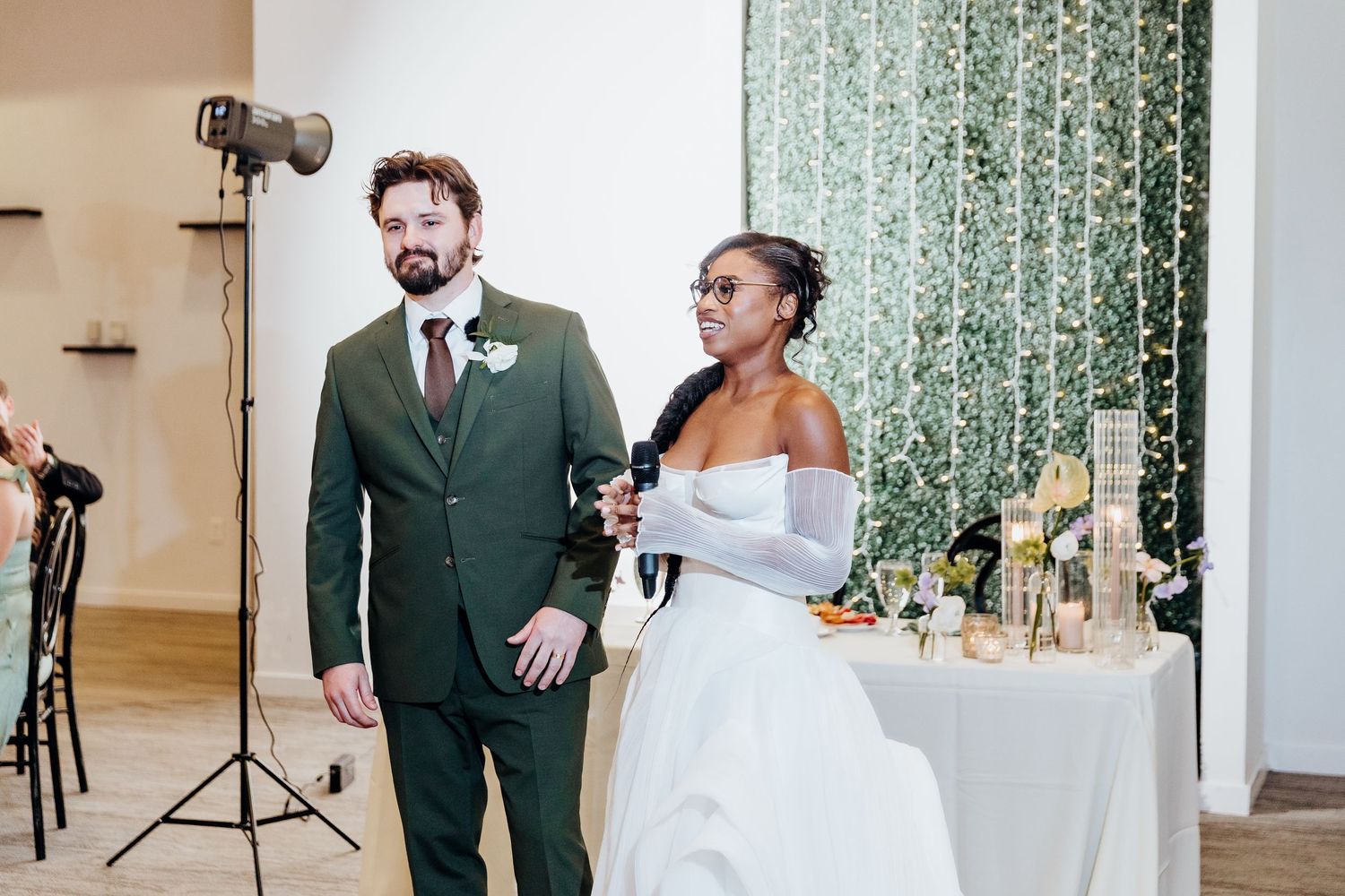 Wedding celebration moments captured in an indoor venue with decorative backdrop.