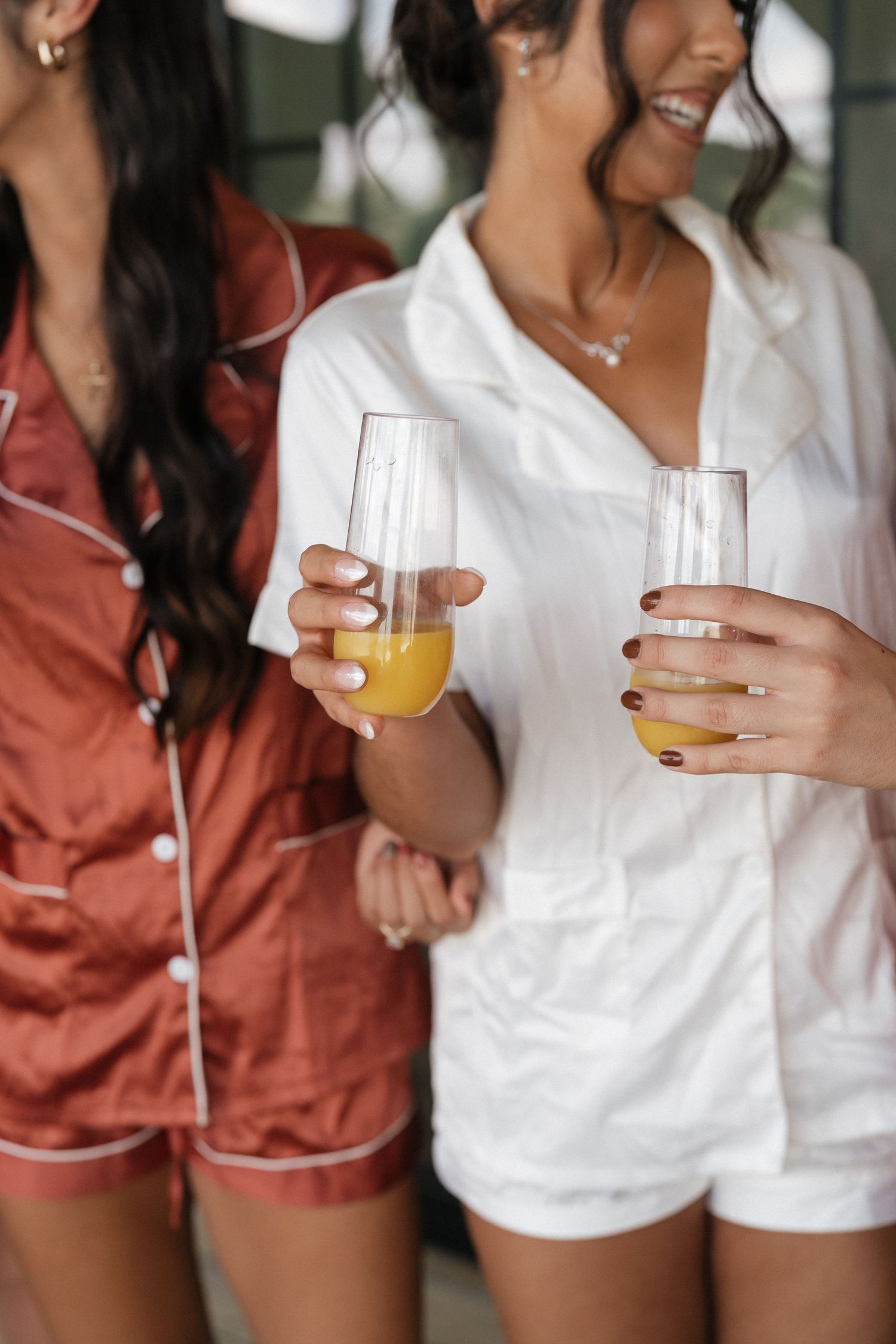 Wedding party enjoying mimosas and drinks before the ceremony in matching robes.