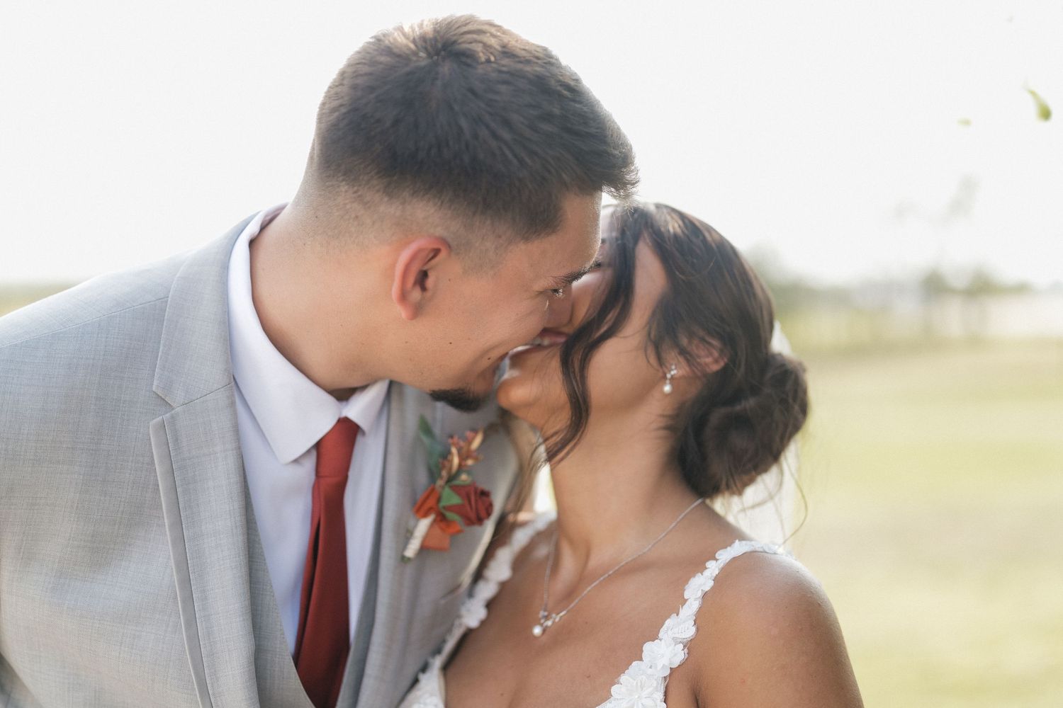 Romantic outdoor wedding portrait in golden sunlight.