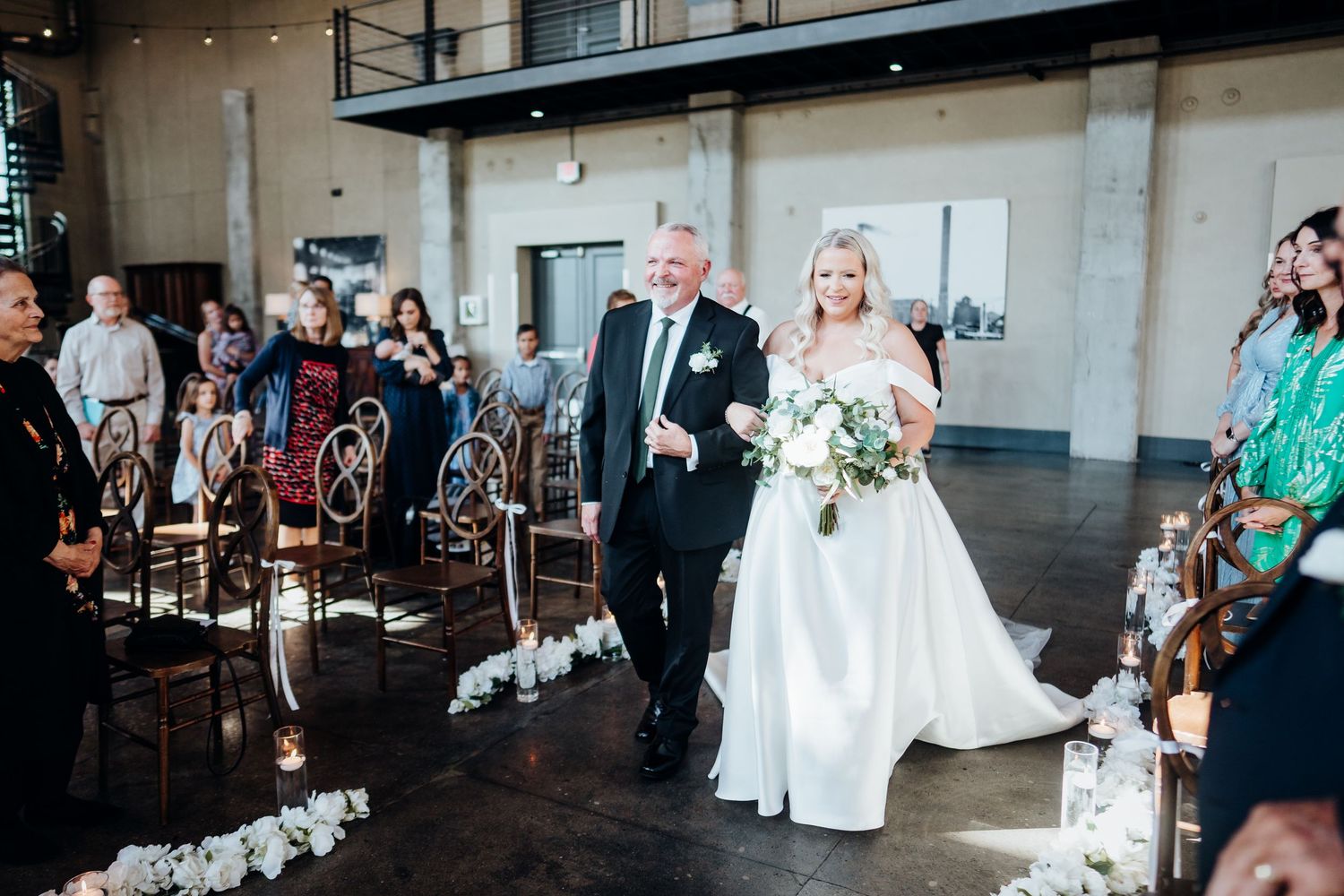 Wedding reception in an industrial-style venue with exposed brick and high ceilings.