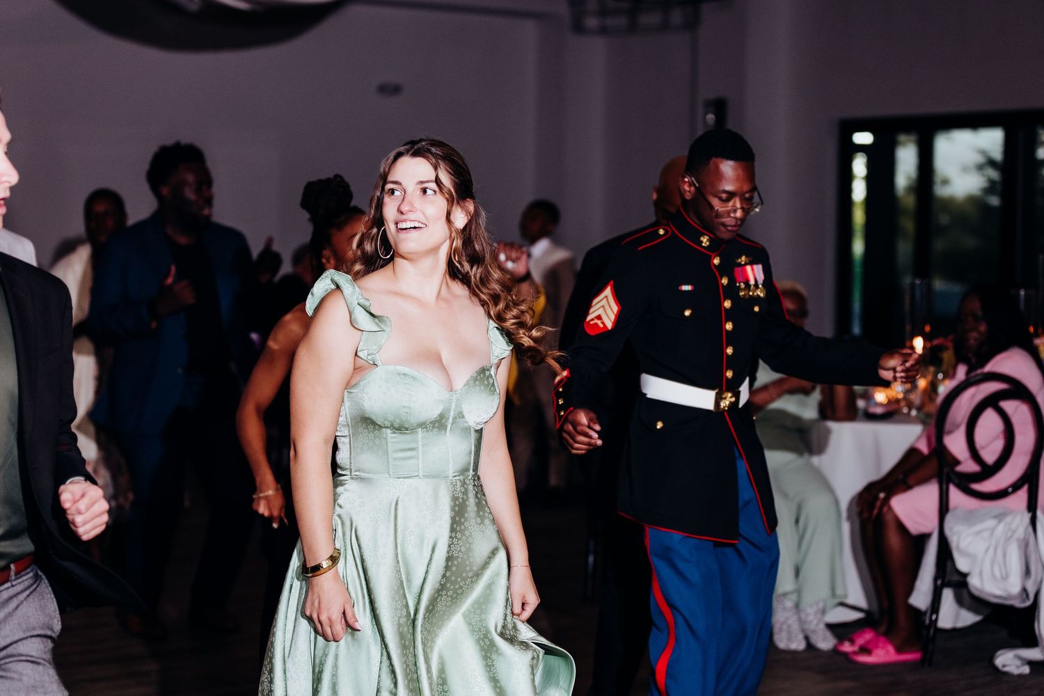 Wedding reception dance floor moments captured in low light setting.