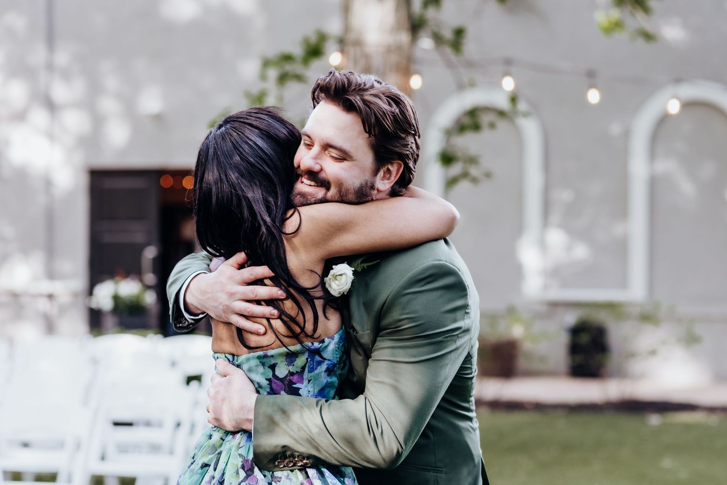 Emotional wedding moments shared between guests during outdoor celebration.