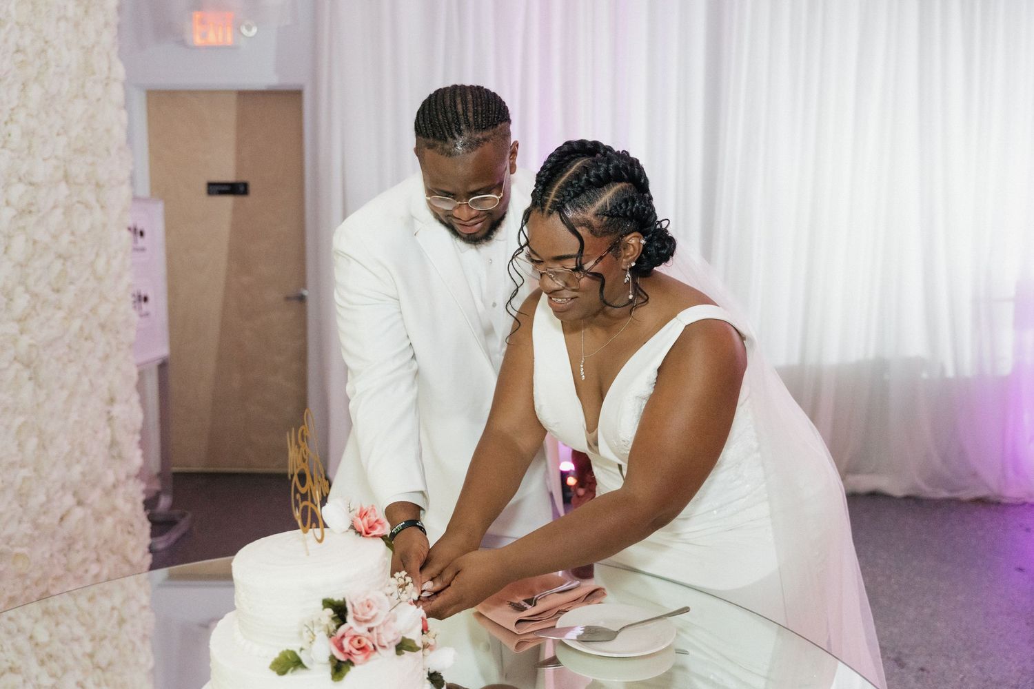 A joyful wedding celebration moment captured in an elegant white-decorated reception venue.
