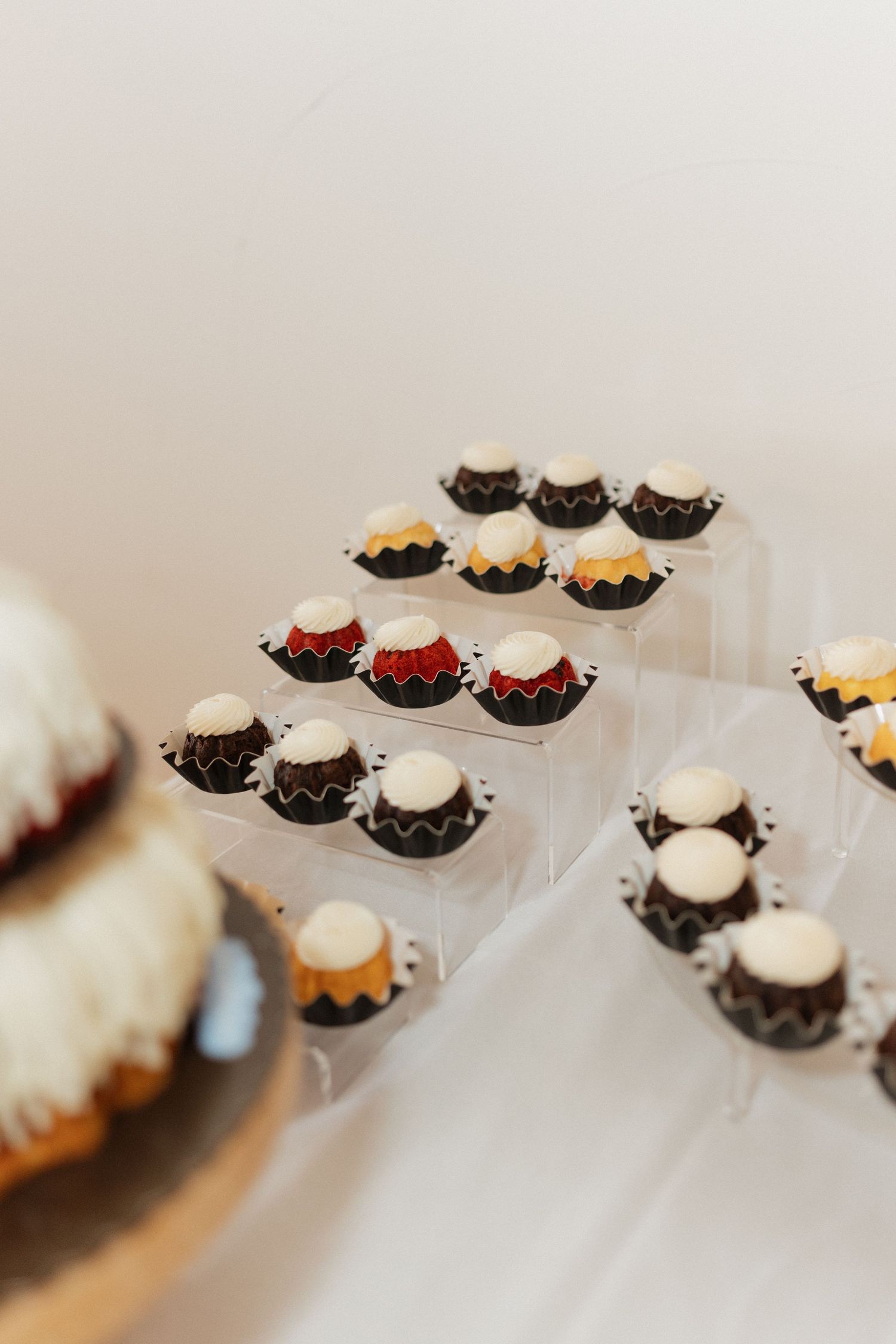 Elegant display of mini desserts arranged in white serving dishes.
