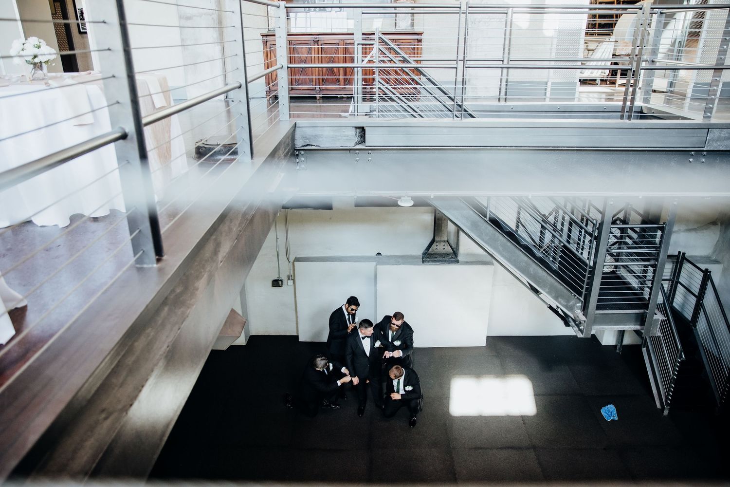 Modern industrial wedding venue with large windows and minimalist architectural details.