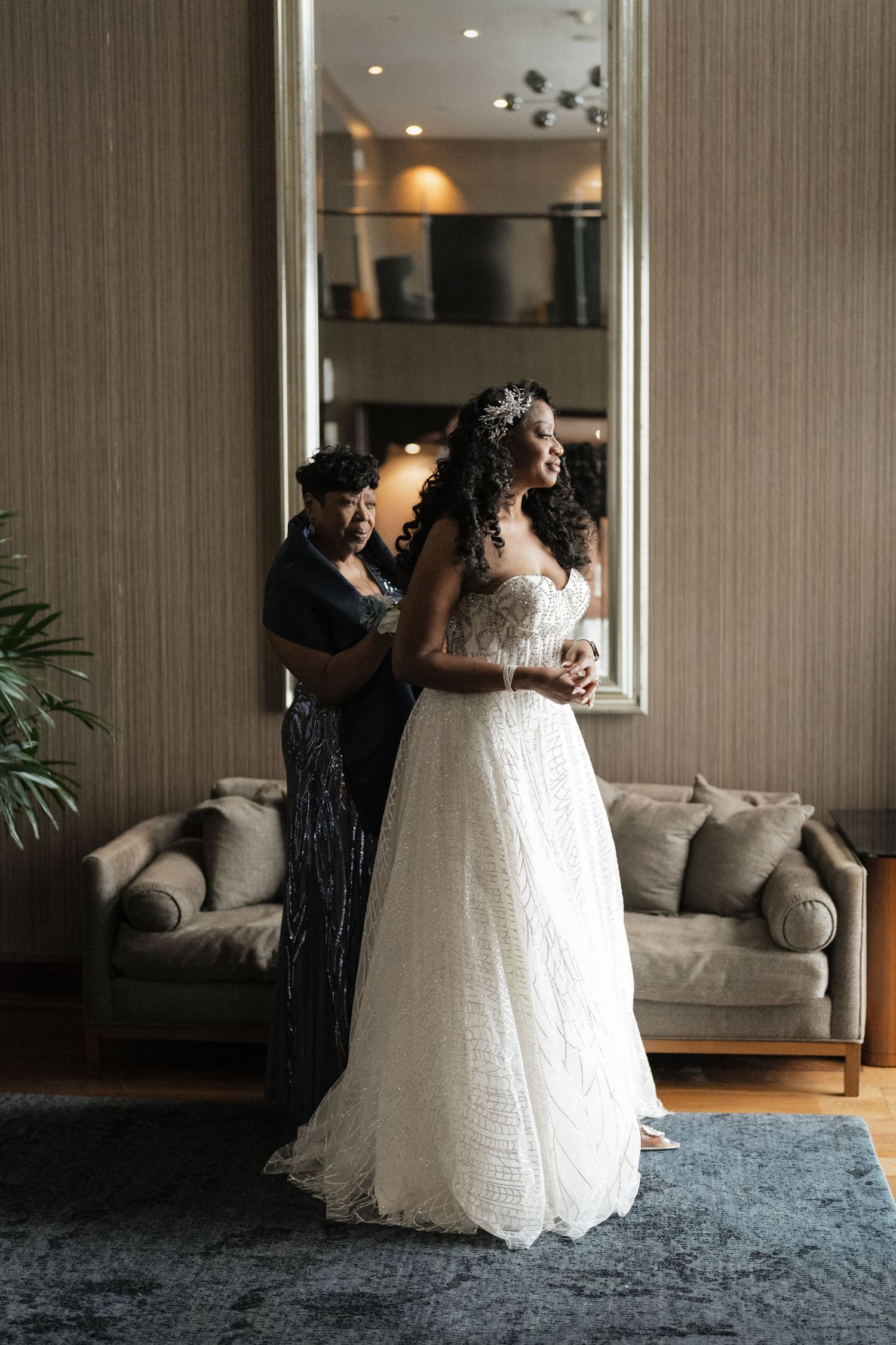 Bride and her mom getting ready near window for downtown cleveland, ohio wedding
