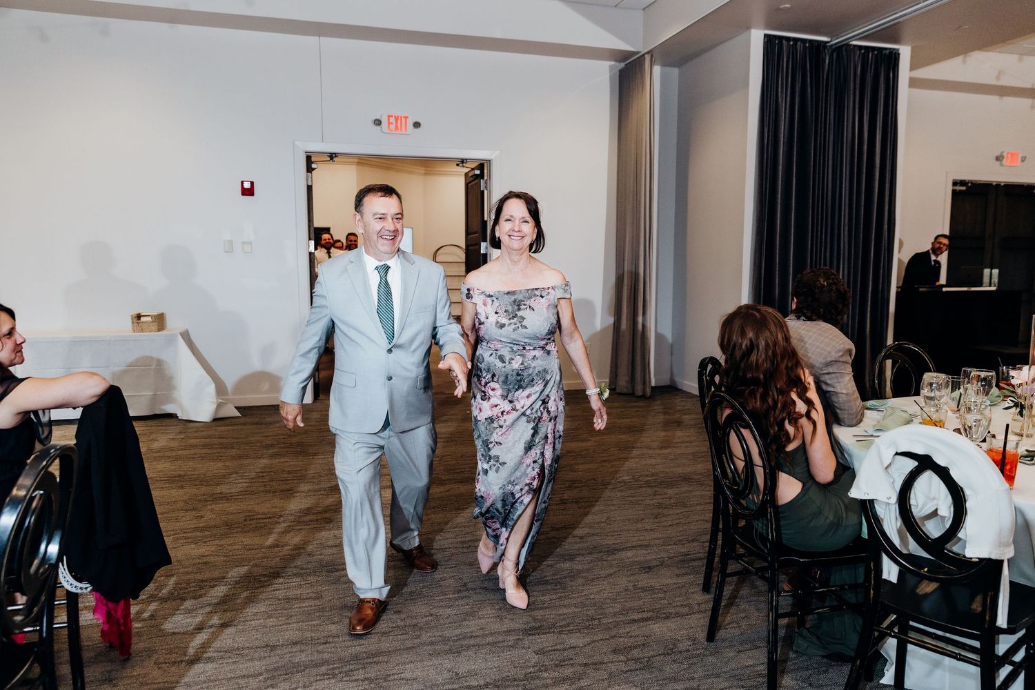 Reception venue interior with hardwood floors and modern event setup.
