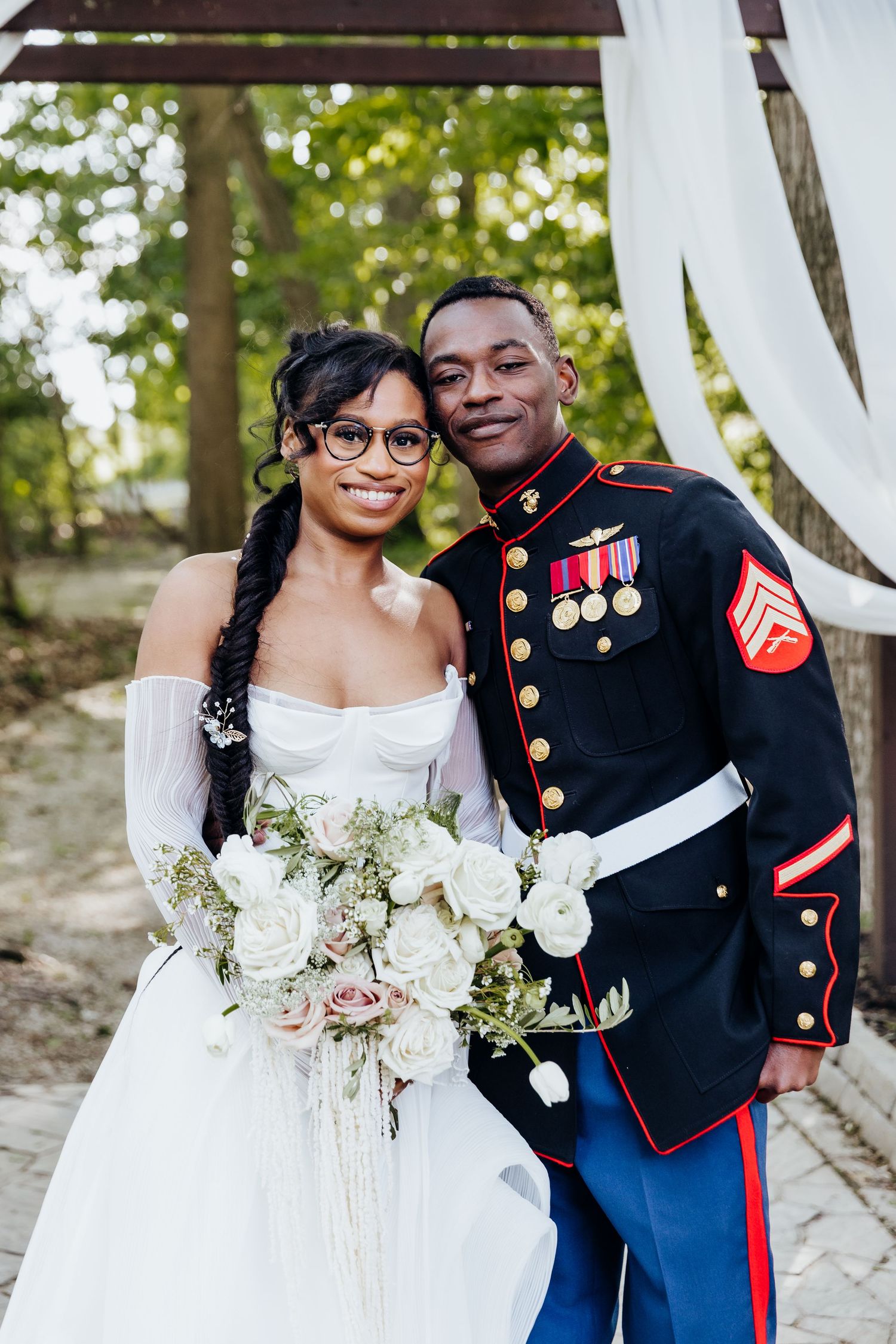 Romantic wedding portraits featuring a bride in white dress and groom in military dress uniform.