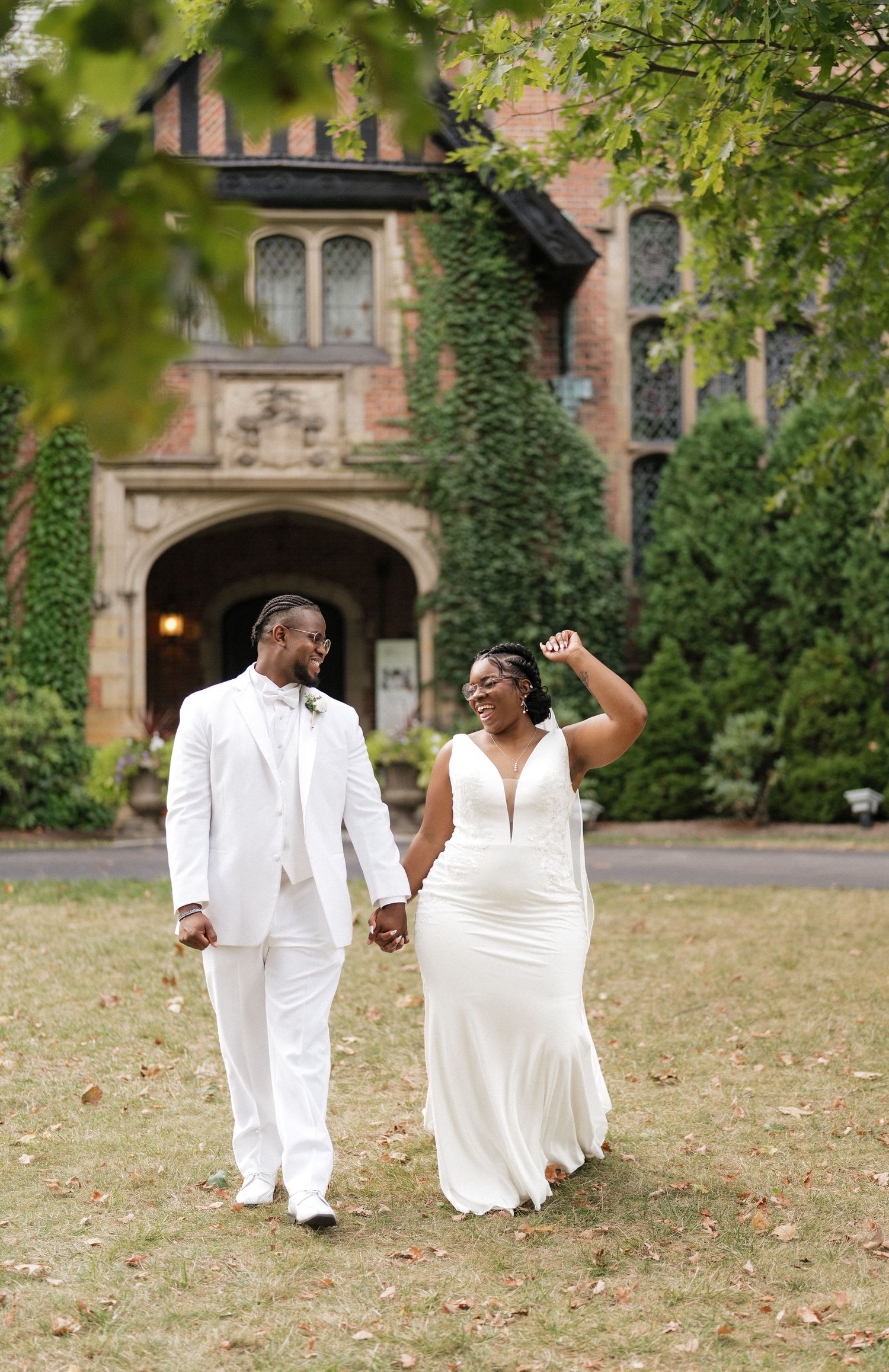 Joyful wedding couple walking and dancing on autumn grounds.