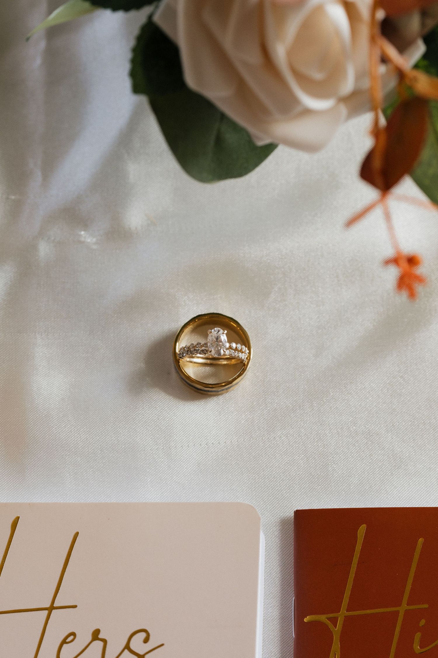 Close-up of wedding rings and name cards with elegant gold lettering.