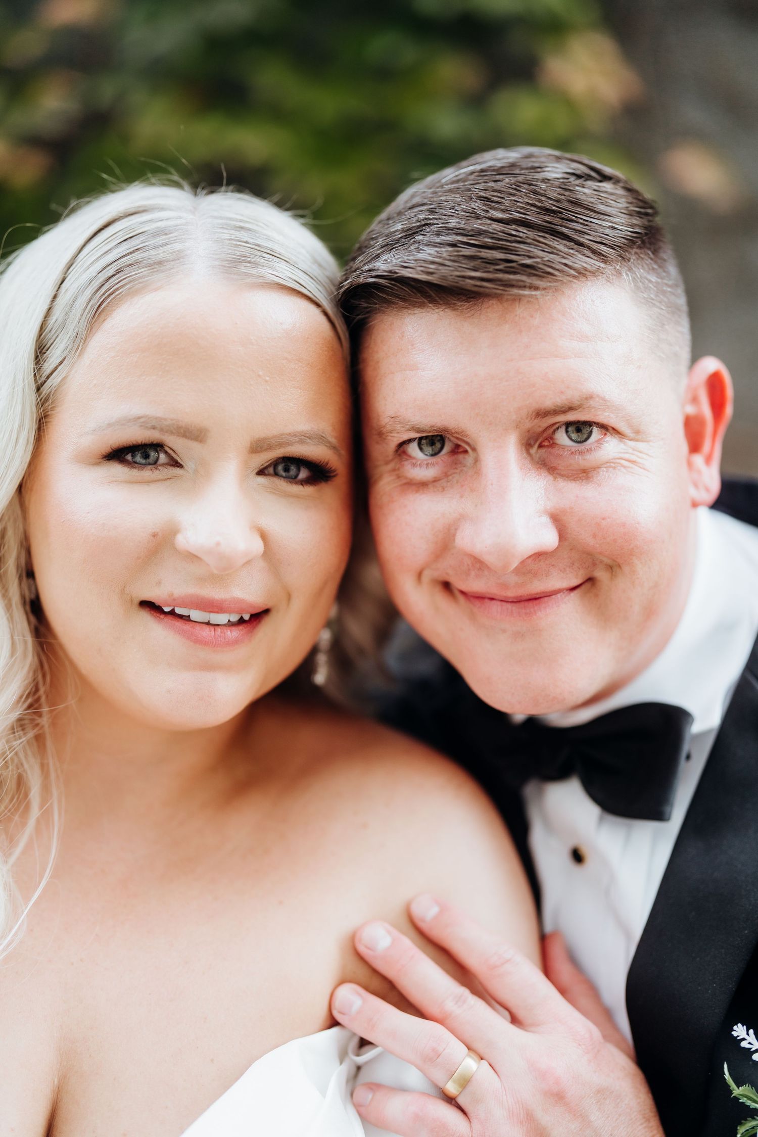 Close-up portrait of couple in wedding attire sharing intimate moments.