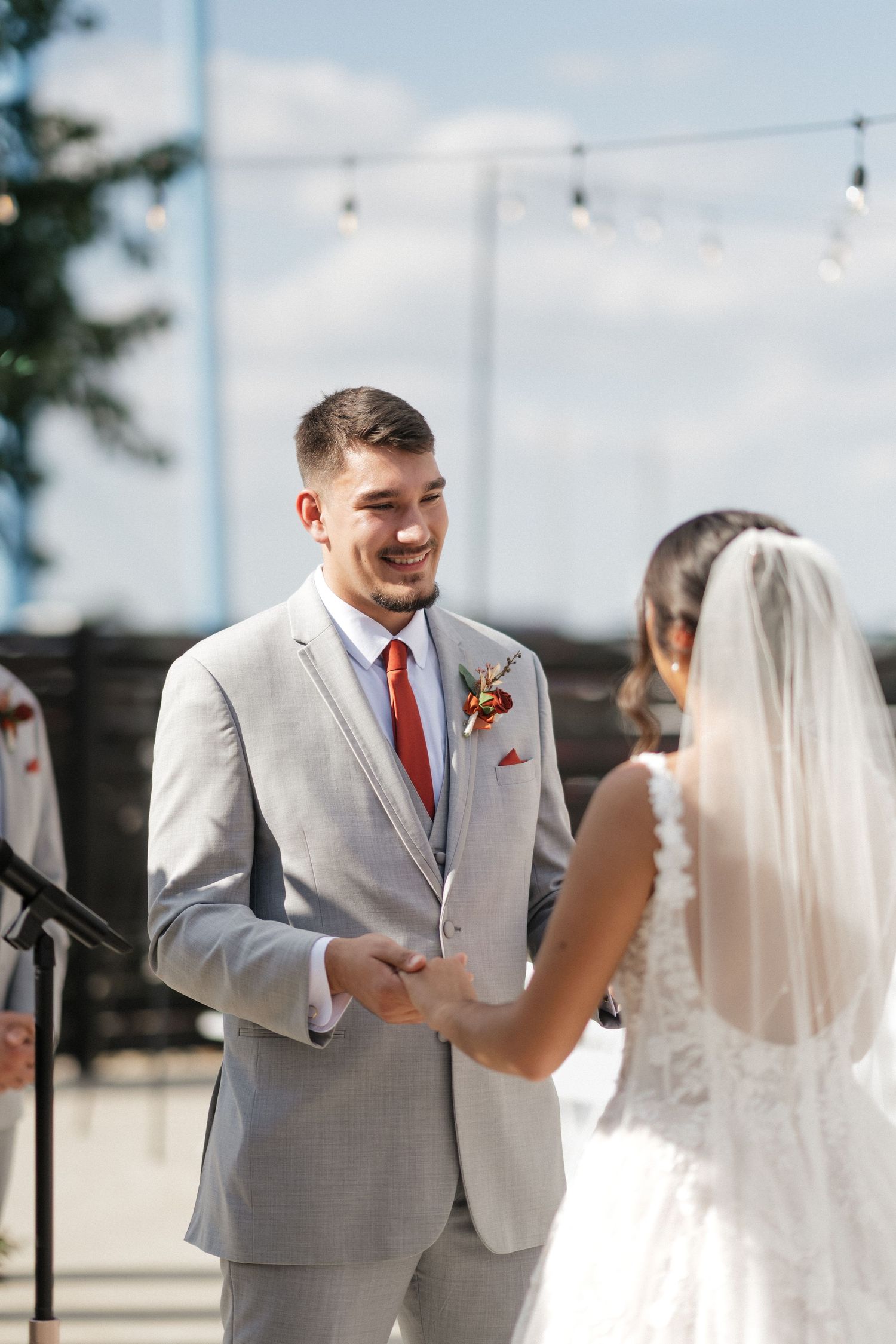 A joyful wedding ceremony moment between a couple exchanging vows outdoors.