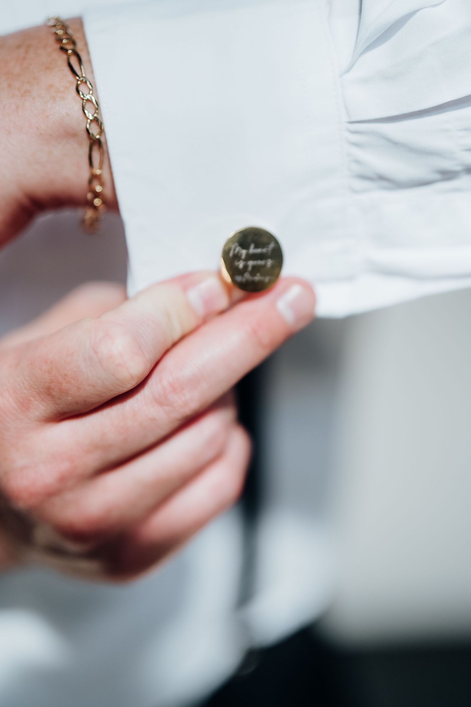 Close-up detail shots of white dress shirt cuffs and accessories in soft lighting.