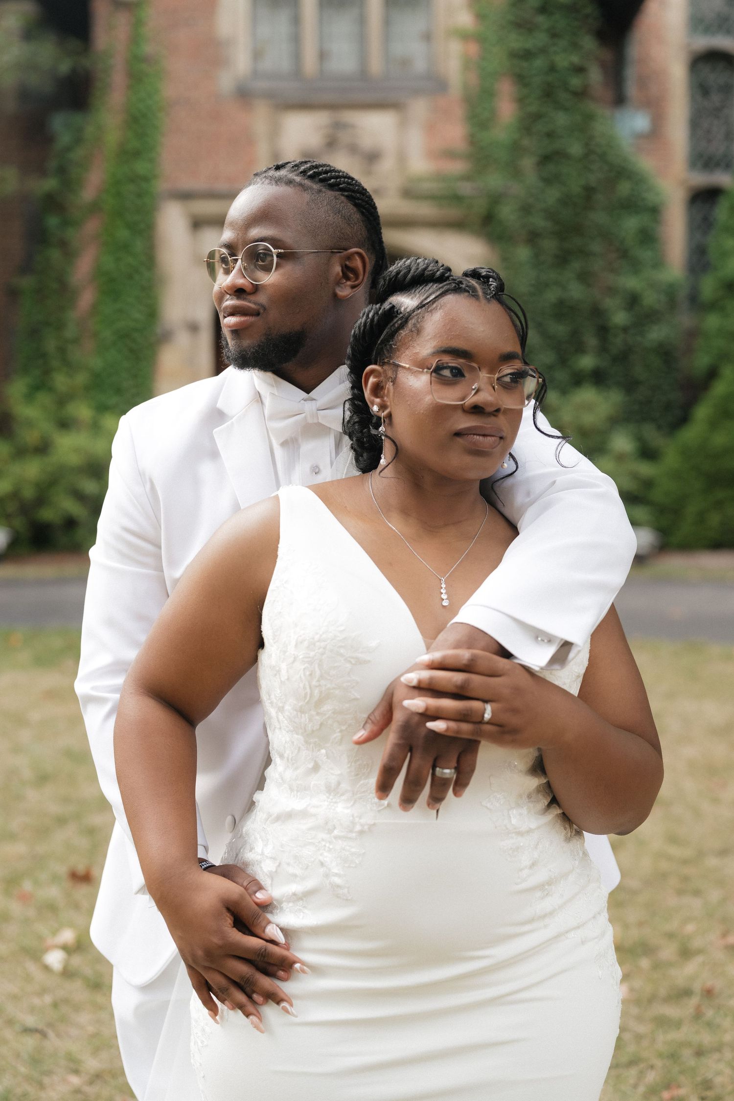 Intimate wedding portrait session in front of an ivy-covered brick building.