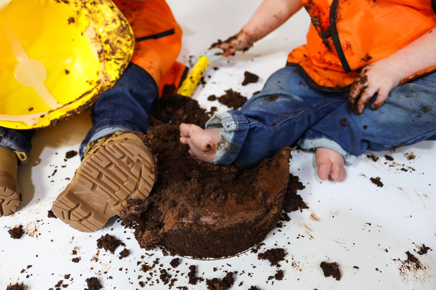 Chocolate cake smash photography session with construction theme elements.
