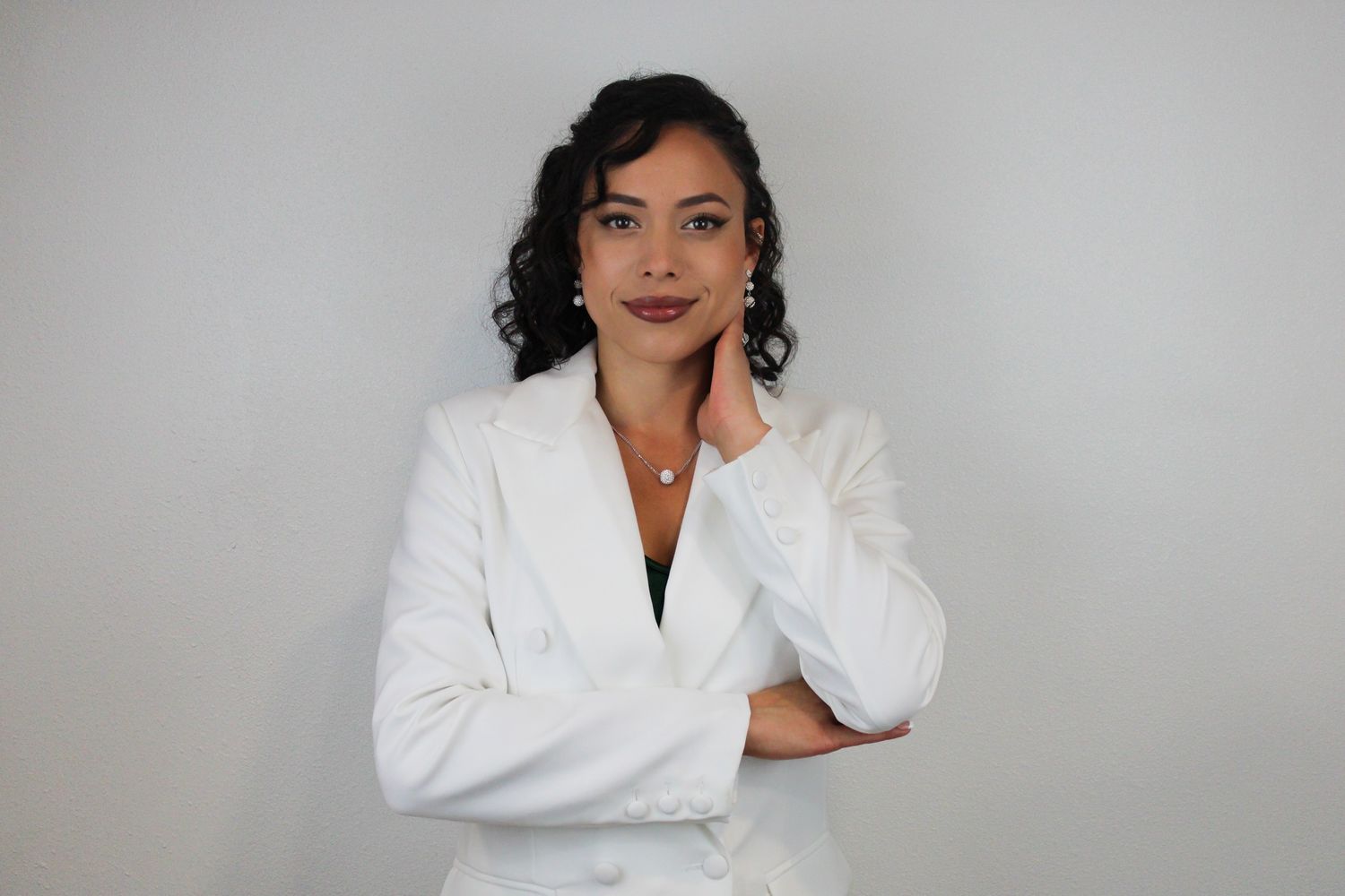 Professional headshots of woman in white blazer against grey background.