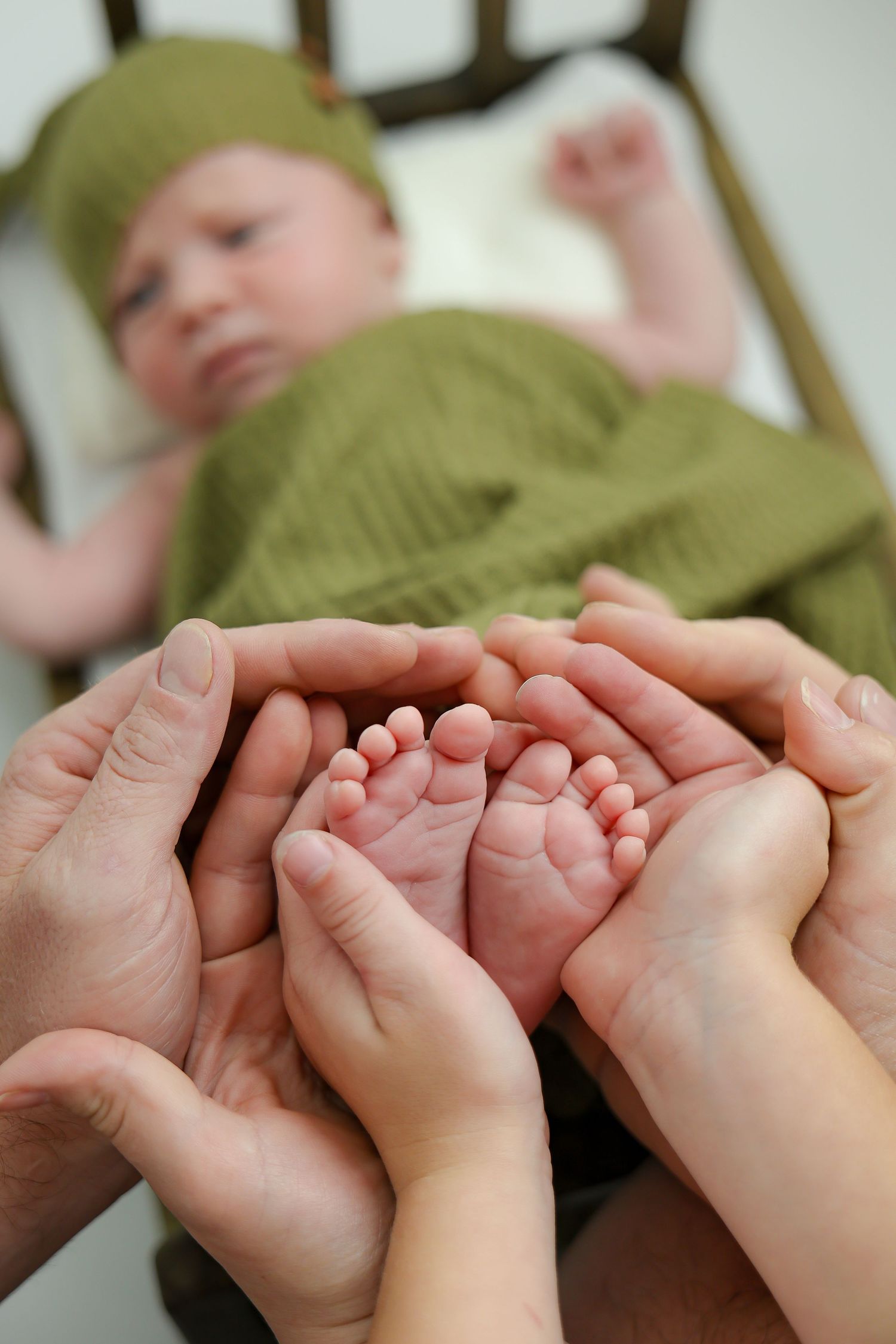 Adult hands gently hold tiny baby feet in a tender sequence of close-up photos showing loving parental care.