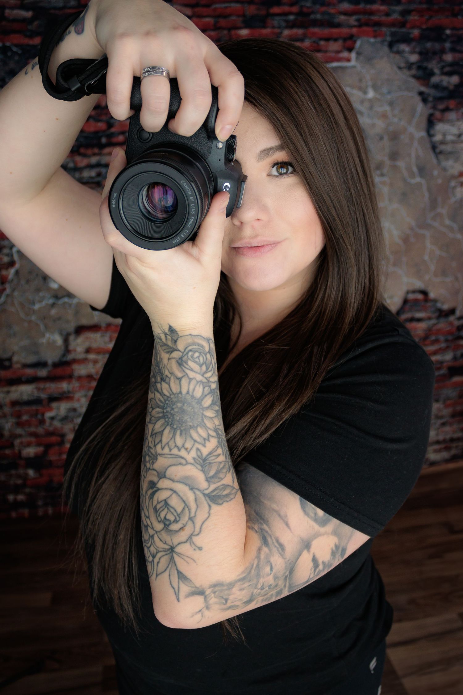 Creative self-portrait series of a photographer with camera and visible arm tattoos.
