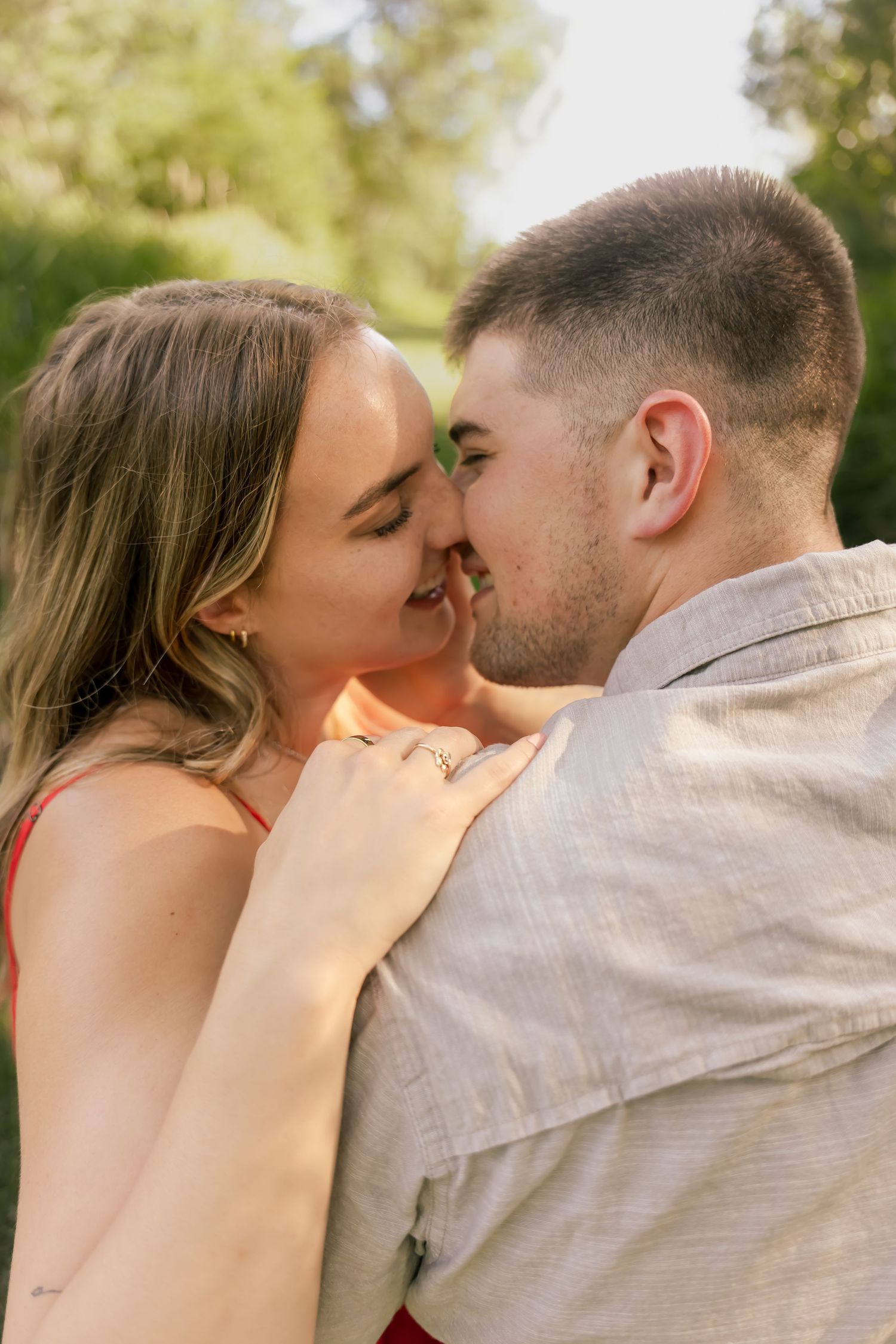 Close-up romantic moment captured in natural outdoor lighting.